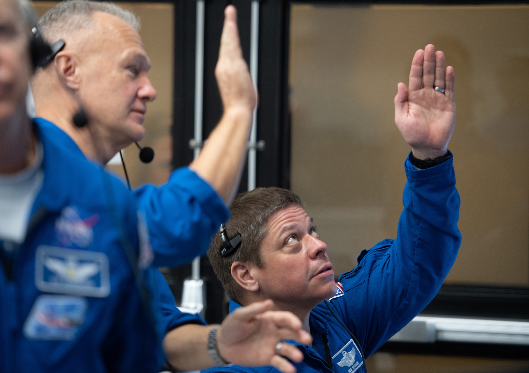 NASA astronauts Doug Hurley, left, and Bob Behnken, right, who are assigned to fly on the crewed Demo-2 mission, watch the launch of a SpaceX Falcon 9 rocket carrying the company's Crew Dragon spacecraft on the Demo-1 mission from firing room four of the Launch Control Center, Saturday, March 2, 2019 at the Kennedy Space Center in Florida. The Demo-1 mission will be the first launch of a commercially built and operated American spacecraft and space system designed for humans as part of NASA's Commercial Crew Program. The mission will serve as an end-to-end test of the system's capabilities.