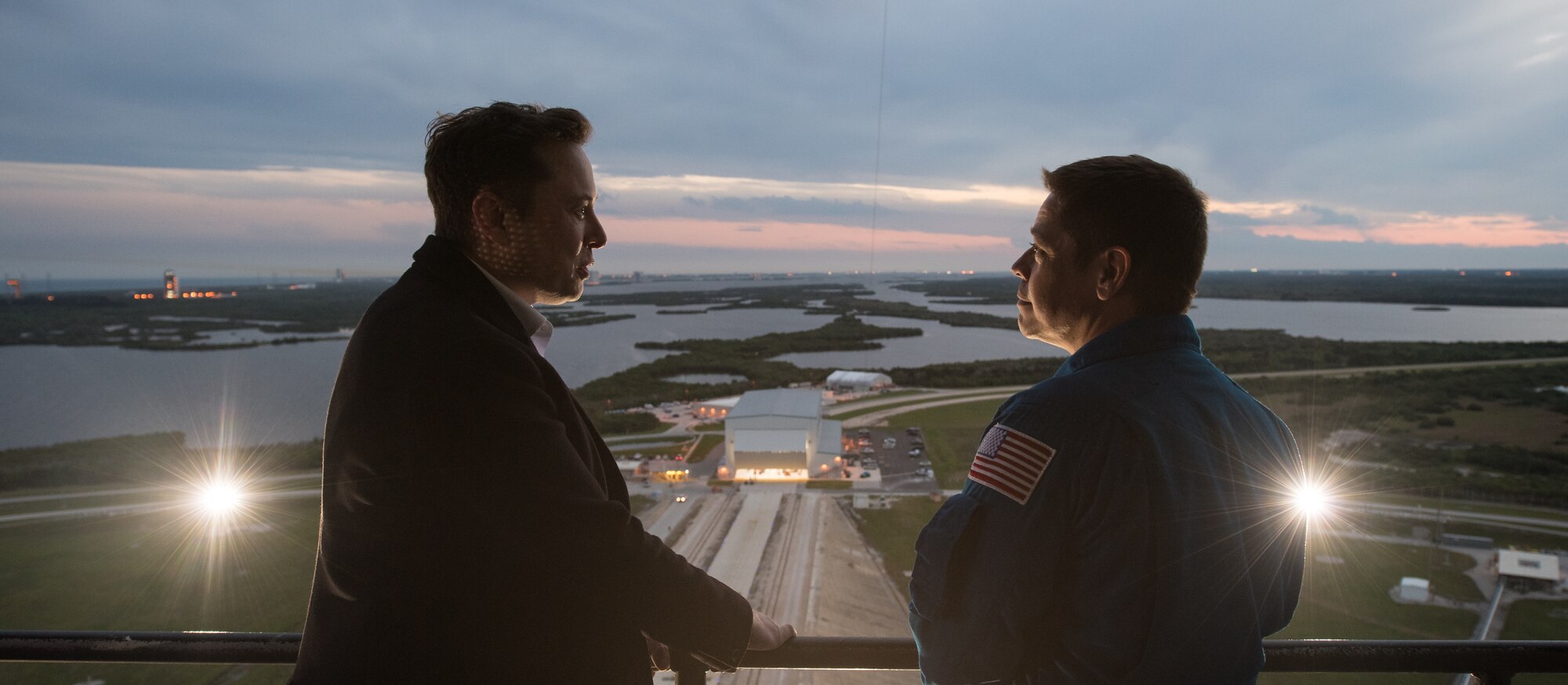 SpaceX CEO and Chief Designer Elon Musk, left, speaks with NASA astronaut Bob Behnken on the fixed service structure of Launch Complex 39A during a tour before the early Sunday morning launch of the Demo-1 mission, Friday, March 1, 2019 at the Kennedy Space Center in Florida. The Demo-1 mission launched at 2:49am ET on Saturday, March 2 and was the first launch of a commercially built and operated American spacecraft and space system designed for humans as part of NASA's Commercial Crew Program. The mission will serve as an end-to-end test of the system's capabilities. Behnken and fellow NASA astronaut Doug Hurley are assigned to fly onboard Crew Dragon for the Demo-2 mission. Photo Credit: (NASA/Joel Kowsky)