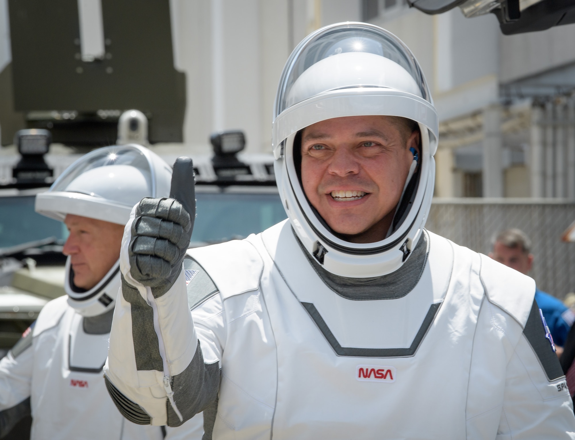 NASA astronauts Robert Behnken, foreground, and Douglas Hurley, wearing SpaceX spacesuits, are seen as they depart the Neil A. Armstrong Operations and Checkout Building for Launch Complex 39A to board the SpaceX Crew Dragon spacecraft for the Demo-2 mission launch, Saturday, May 30, 2020, at NASA’s Kennedy Space Center in Florida. NASA’s SpaceX Demo-2 mission is the first launch with astronauts of the SpaceX Crew Dragon spacecraft and Falcon 9 rocket to the International Space Station as part of the agency’s Commercial Crew Program. The test flight serves as an end-to-end demonstration of SpaceX’s crew ransportation system. Behnken and Hurley are scheduled to launch at 3:22 p.m. EDT on Saturday, May 30, from Launch Complex 39A at the Kennedy Space Center. A new era of human spaceflight is set to begin as American astronauts once again launch on an American rocket from American soil to low-Earth orbit for the first time since the conclusion of the Space Shuttle Program in 2011.  Photo Credit: (NASA/Bill Ingalls)