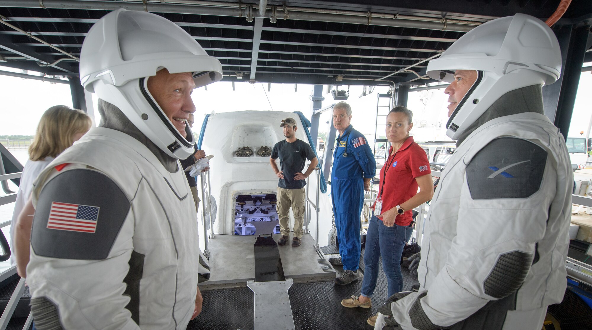 NASA astronauts Doug Hurley, left, and Bob Behnken work with teams from NASA and SpaceX to rehearse crew extraction from SpaceX’s Crew Dragon, which will be used to carry humans to the International Space Station, on August 13, 2019 at the Trident Basin in Cape Canaveral, Florida. Using the Go Searcher ship SpaceX uses to recover their spacecraft after splashdown and a mock-up of the Crew Dragon, the teams worked through the steps necessary to get NASA astronauts Doug Hurley and Bob Behnken out of the Dragon and back to dry land. Hurley and Behnken will fly to the space station aboard the Crew Dragon for the SpaceX Demo-2 mission. Photo Credit: (NASA/Bill Ingalls)