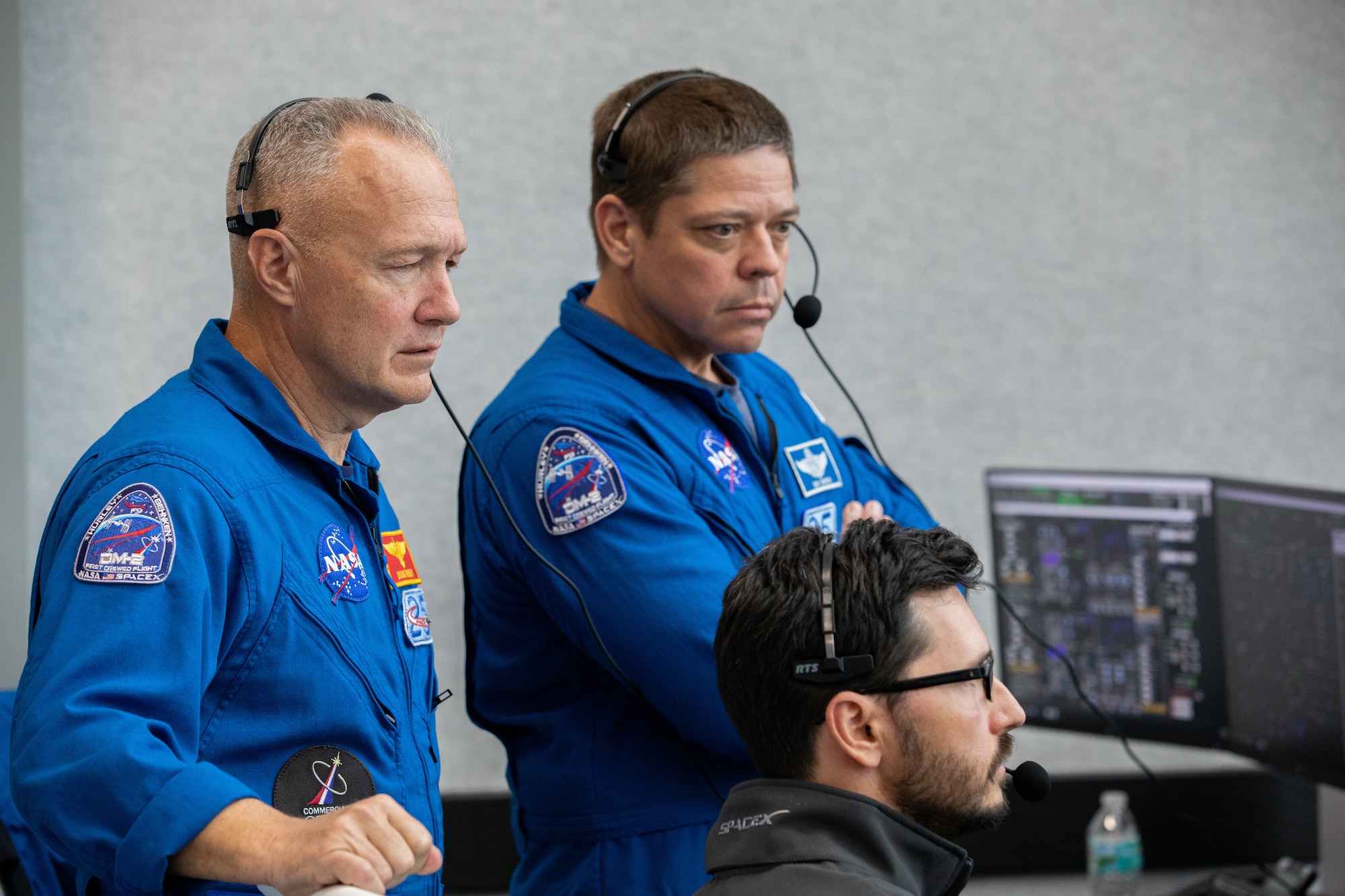 NASA astronauts Doug Hurley, left, and Bob Behnken watch the liftoff of a SpaceX Falcon 9 rocket and Crew Dragon spacecraft on the uncrewed In-Flight Abort Test, Jan. 19, 2020, inside Firing Room 4 in Kennedy Space Center’s Launch Control Center. The test demonstrated the spacecraft’s escape capabilities in preparation for crewed flights to the International Space Station as part of the agency’s Commercial Crew Program.
