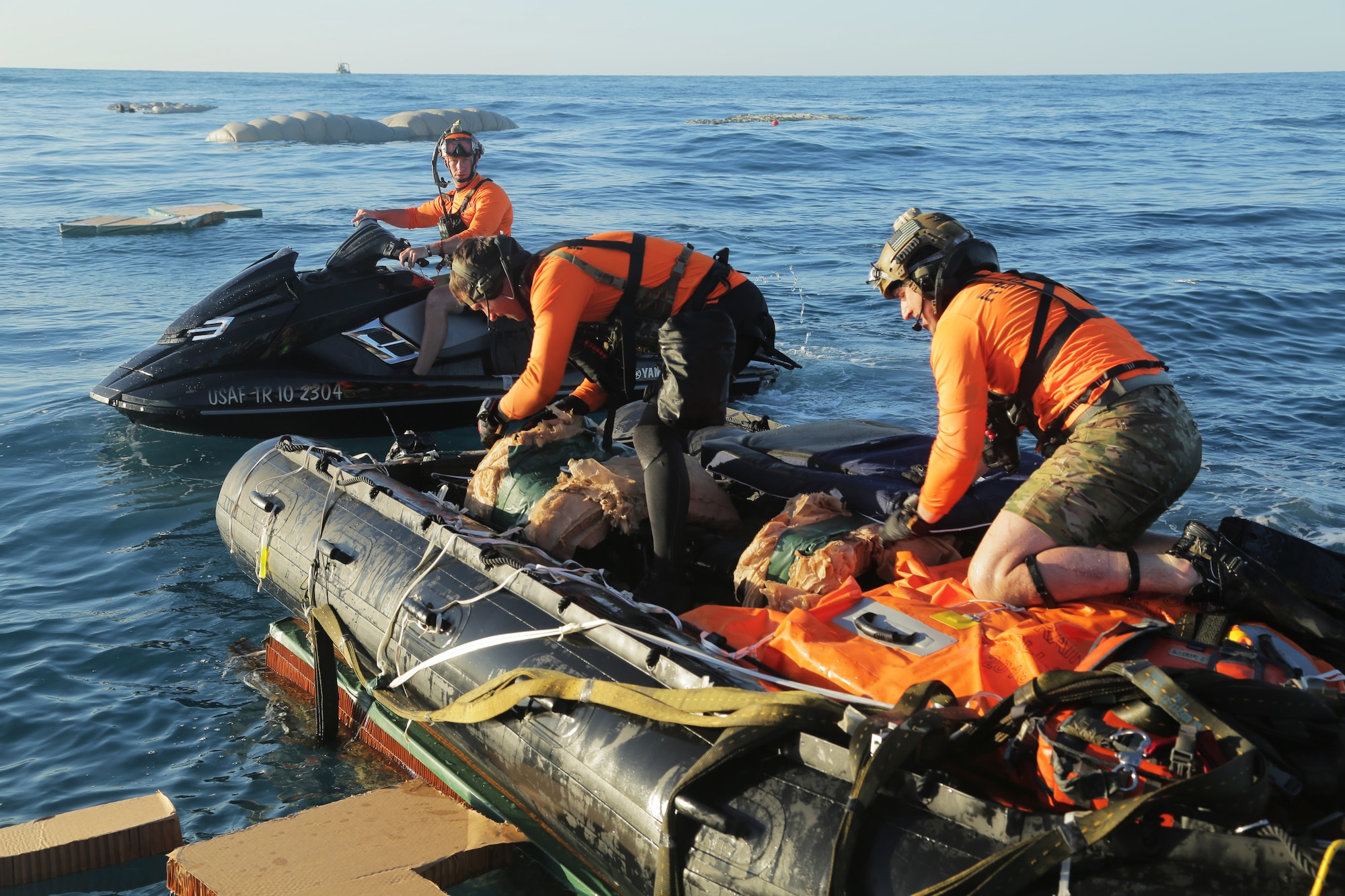 Pararescue specialists from the 304th Rescue Squadron, located in Portland, Oregon and supporting the 45th Operations Group’s Detachment 3, based out of Patrick Air Force Base, prepare equipment during an April astronaut rescue exercise with NASA’s Commercial Crew Program and SpaceX off of Florida’s eastern coast. The pararescue specialists, also known as “Guardian Angels,” jumped from military aircraft and simulated a rescue operation to demonstrate their ability to safely remove crew from the SpaceX Crew Dragon in the unlikely event of an emergency landing. The pararescue specialists are fully qualified paramedics able to perform field surgery, if necessary.