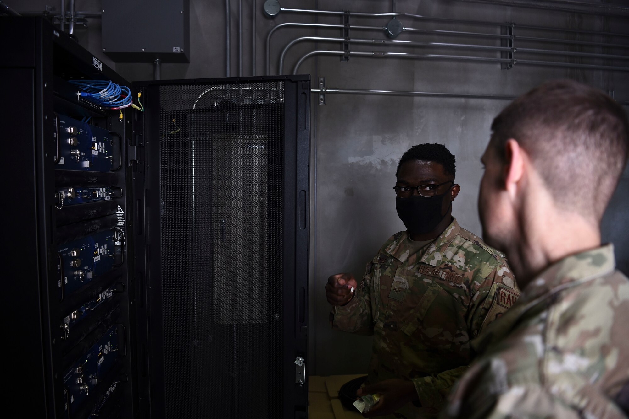 U.S. Air Force Airman 1st Class Simisola Mark, 35th Operations Support Squadron radar airfield weather system technician, explains a radio rack to Col. Timothy Murphy, 35th Fighter Wing vice commander, during a Wild Weasel Walk-Through at Misawa Air Base, Japan, May 24, 2021.