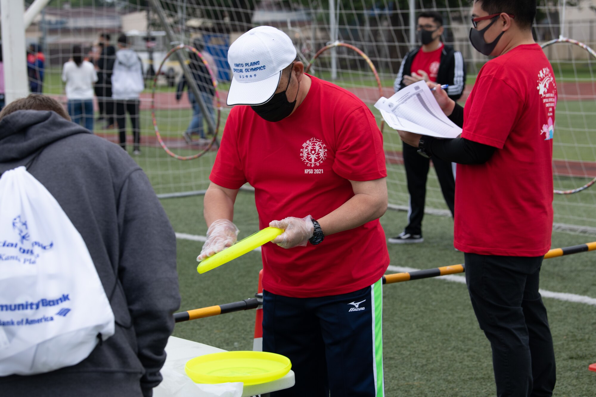 A volunteer cleans a flying disk during the Kanto Plains Special Olympics