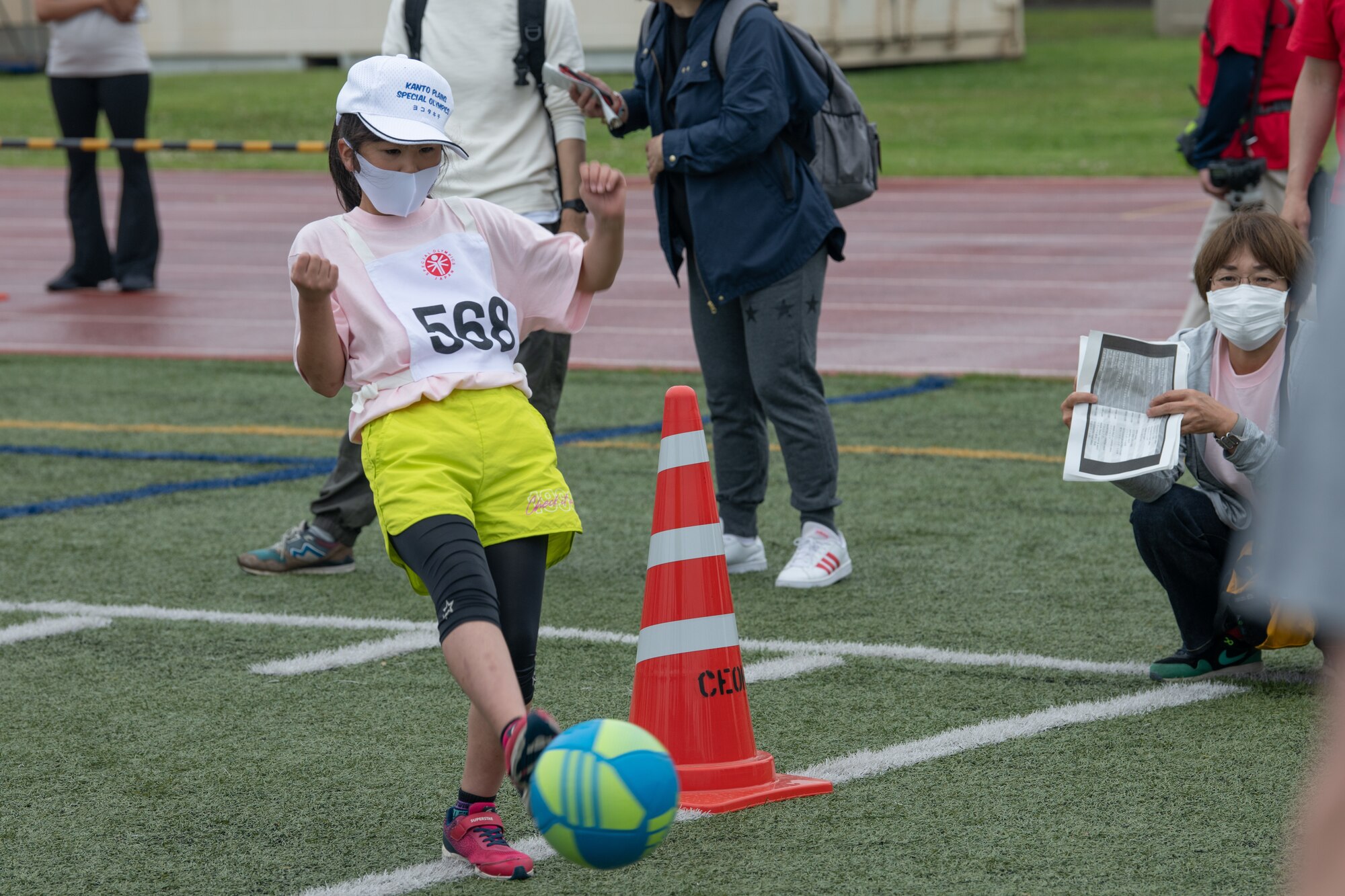 An athlete kicks a soccer ball during the Kanto Plains Special Olympics