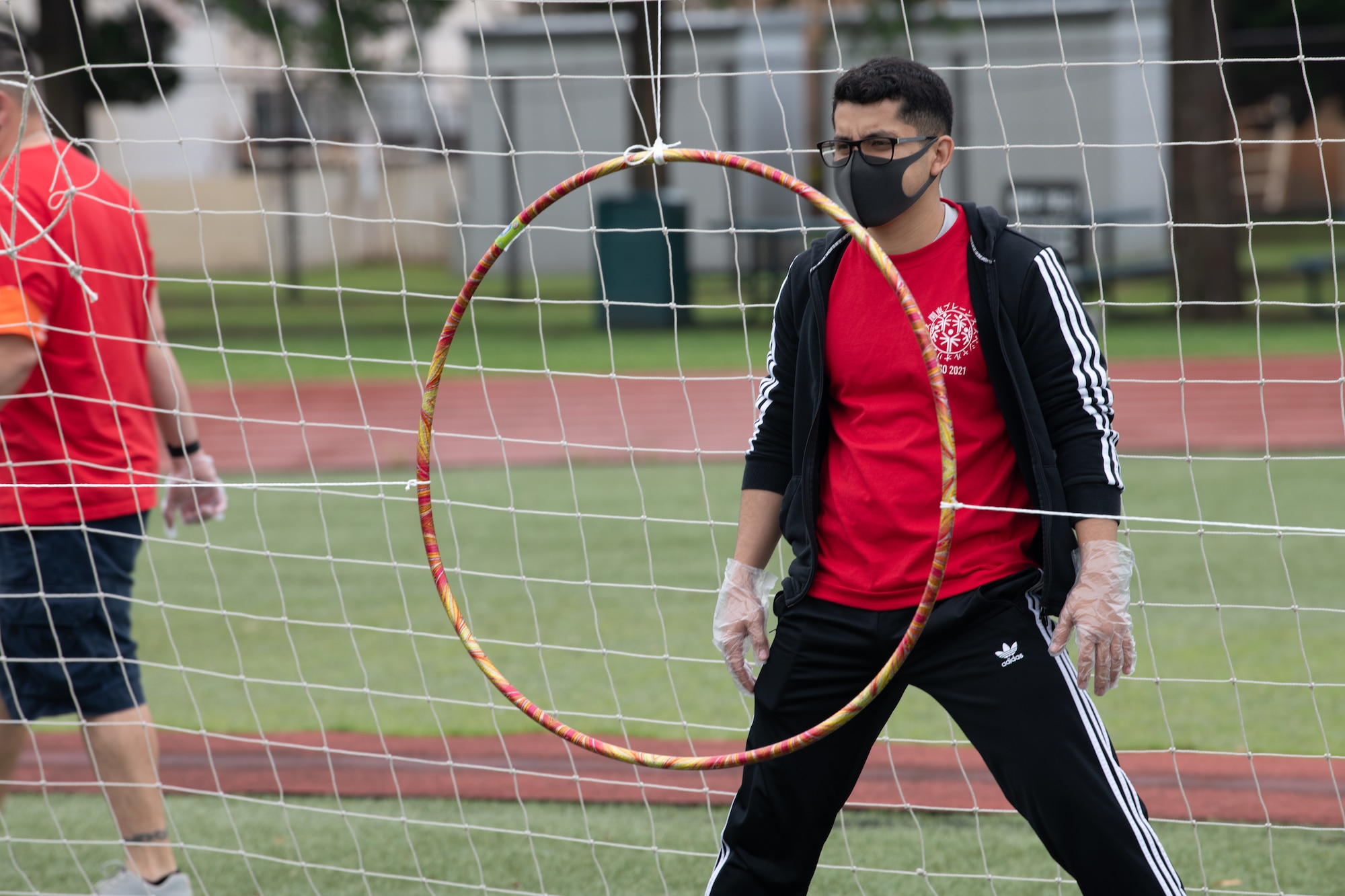 A volunteer waits to catch a disk during the Kanto Plains Special Olympics