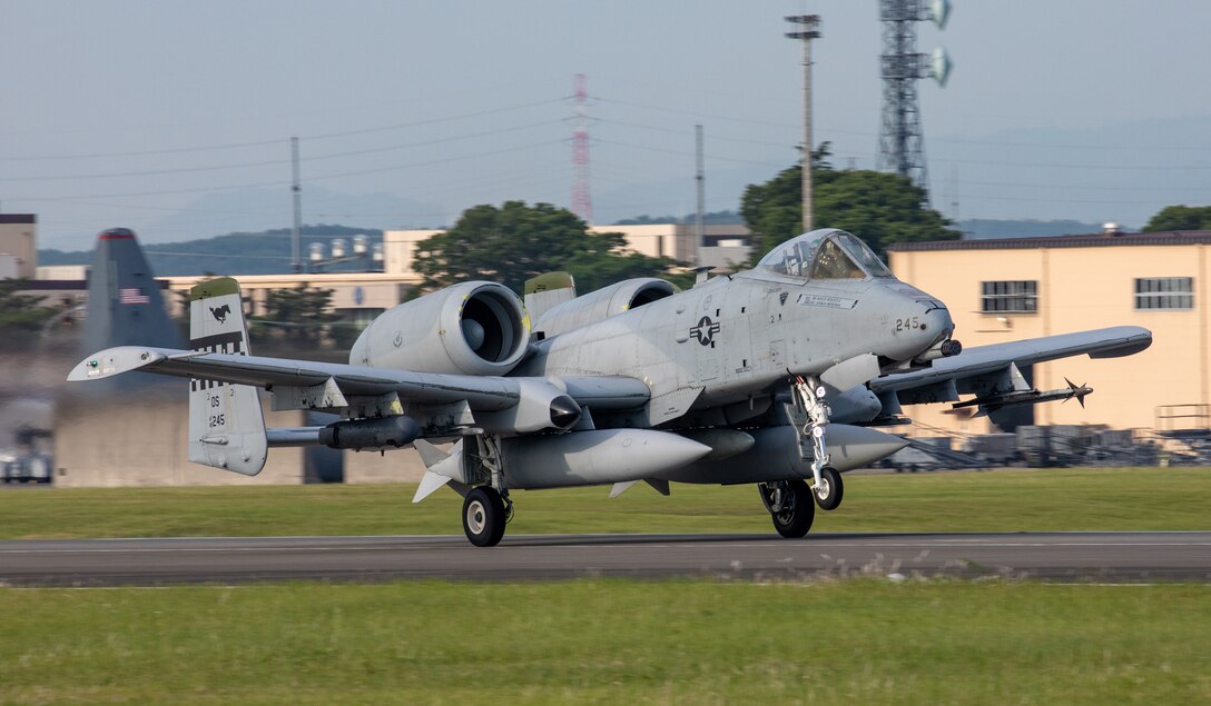 An A-10 Thunderbolt II aircraft takes off on a flightline