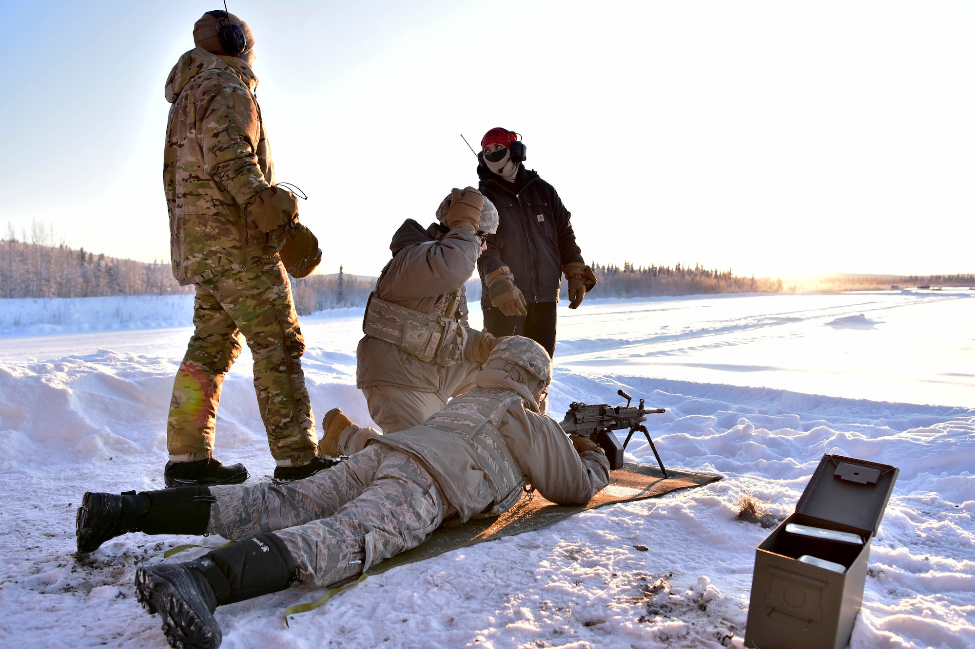 354th Security Forces Squadron Combat Arms Training and Maintenance (CATM) instructors oversee Airmen preparing to fire an M-249 Squad Automatic Weapon at Eielson Air Force Base, Alaska, Jan. 9, 2020. CATM instructors are responsible for training Airmen how to use various small arms weapon systems. (U.S. Air Force photo by Senior Airman Beaux Hebert)