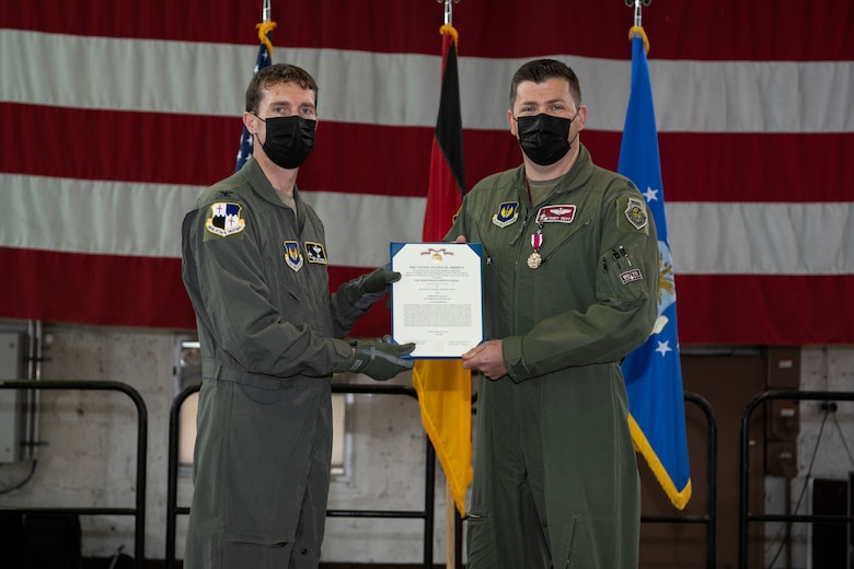 U.S. Air Force Col. David Epperson, 52nd Fighter Wing commander (left), presents the Meritorious Service Medal to U.S. Air Force Lt. Col. Matthew Hoyt, the outgoing commander of the 52nd Operations Support Squadron, during the 52nd OSS change of command ceremony May 25, 2021, on Spangdahlem Air Base, Germany.