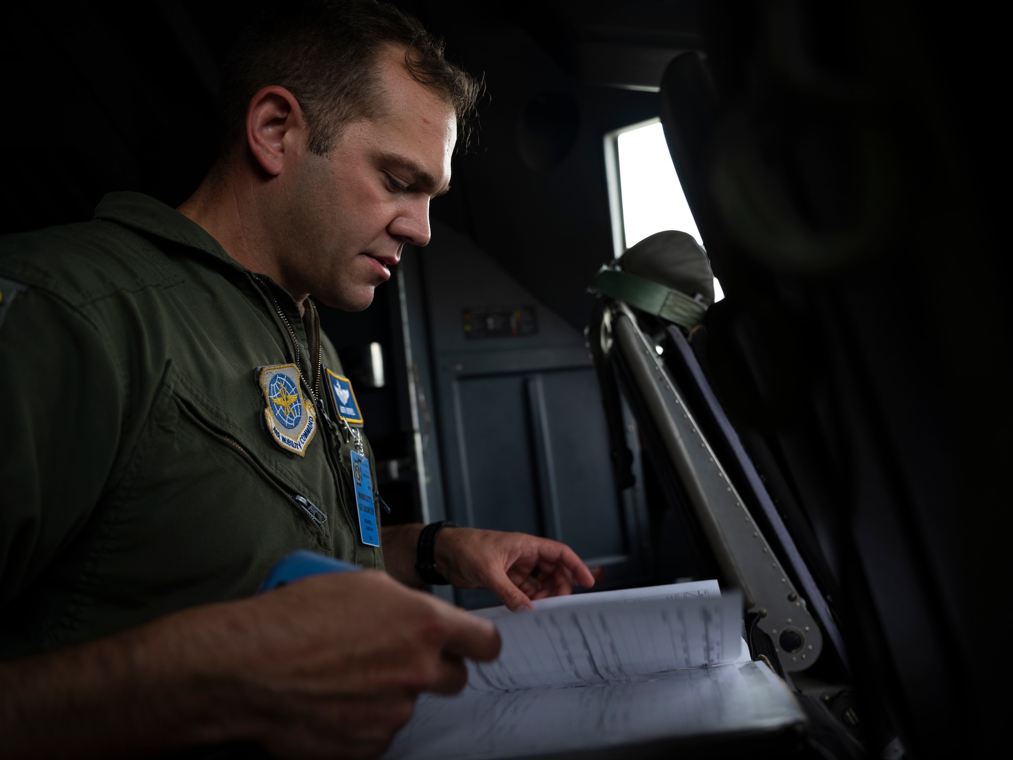 U.S. Air Force Maj. Austin Merkel, a pilot assigned to the 41st Airlift Squadron, reviews flight paperwork on a U.S. Air Force C-130J Super Hercules assigned to the 19th Airlift Wing at Alpena Combat Readiness Training Center, Michigan, May 21, 2021. Mobility Guardian accelerates change for the Air Force and Air Mobility Command by developing the force and advancing warfighting capabilities to enhance our ability to project the Joint Force and ensure strategic deterrence. (U.S. Air Force photo by Staff Sgt. Joseph Pick)