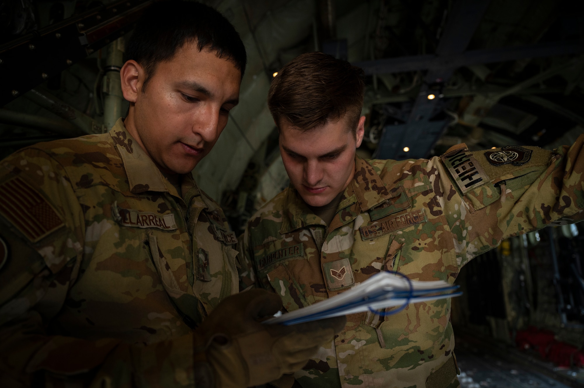 U.S. Air Force Airman 1st Class Jorge Villarreal, left, and U.S. Air Force Senior Airman Jacob Carpenter, loadmasters assigned to the 41st Airlift Squadron, review cargo checklists on a U.S. Air Force C-130J Super Hercules assigned to the 19th Airlift Wing at Alpena Combat Readiness Training Center, Michigan, May 21, 2021. Mobility Guardian accelerates change for the Air Force and Air Mobility Command by developing the force and advancing warfighting capabilities to enhance our ability to project the Joint Force and ensure strategic deterrence. (U.S. Air Force photo by Staff Sgt. Joseph Pick)