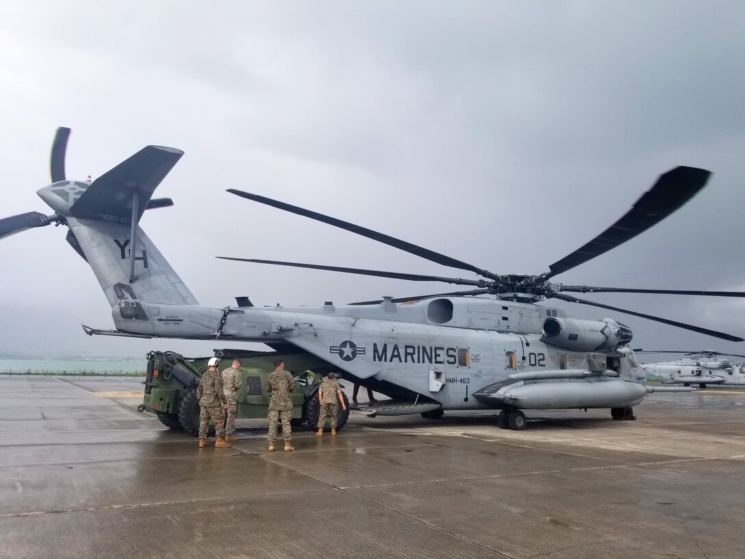 U.S. Marines load lumber and cement into the back of a CH-53 in preparation to send it to Camp Paumalu Girl Scout camp where a joint-service effort is being made to renovate and improve the camp here May 18.