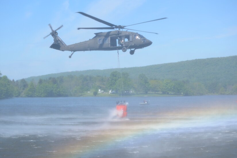 One CH-47 Chinook and two UH-60 Black Hawk helicopters conduct water bucket training May 11 at Memorial Lake State Park and Fort Indiantown Gap in coordination with safety and conservation ground personnel.