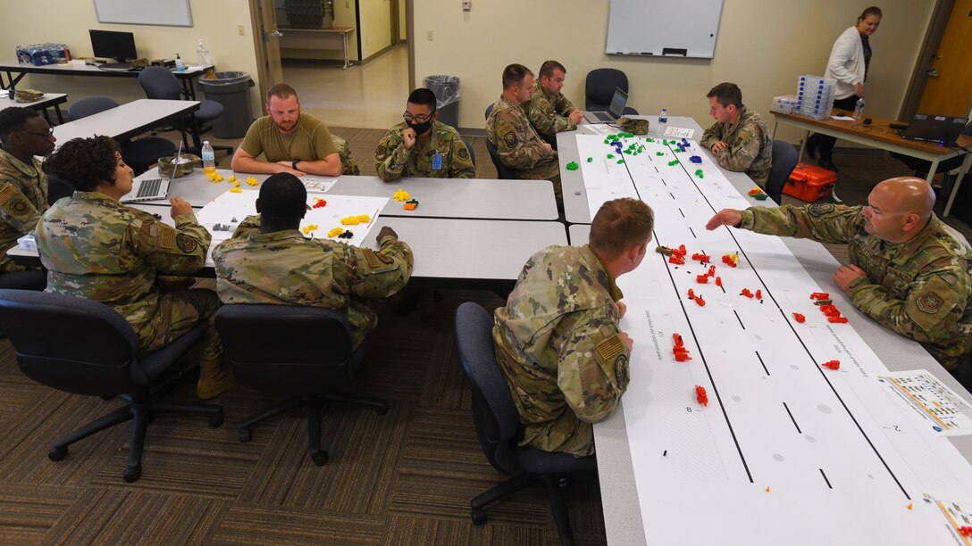 Civil engineering Airmen are introduced to a replica of a damaged flightline during a tabletop exercise at Alpena Combat Readiness Training Center, Mich., May 22, 2021. The purpose of the tabletop exercise was to familiarize civil engineering Airmen with Rapid Airfield Deployment Recovery program and introduce them to scenarios from a leadership perspective during Exercise Mobility Guardian 2021. Mobility Guardian is the Air Force's largest and longest exercise ensuring readiness to move personnel and equipment in combat operations. (U.S. Air Force photo by Tech. Sgt. Kentavist P. Brackin)