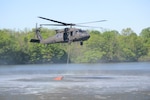 One CH-47 Chinook and two UH-60 Black Hawk helicopters conduct water bucket firefighter training May 11, 2021, at Memorial Lake State Park and Fort Indiantown Gap, Pennsylvania. The Pennsylvania National Guard crews take water from Memorial Lake and drop it in Fort Indiantown Gap’s training corridor.
