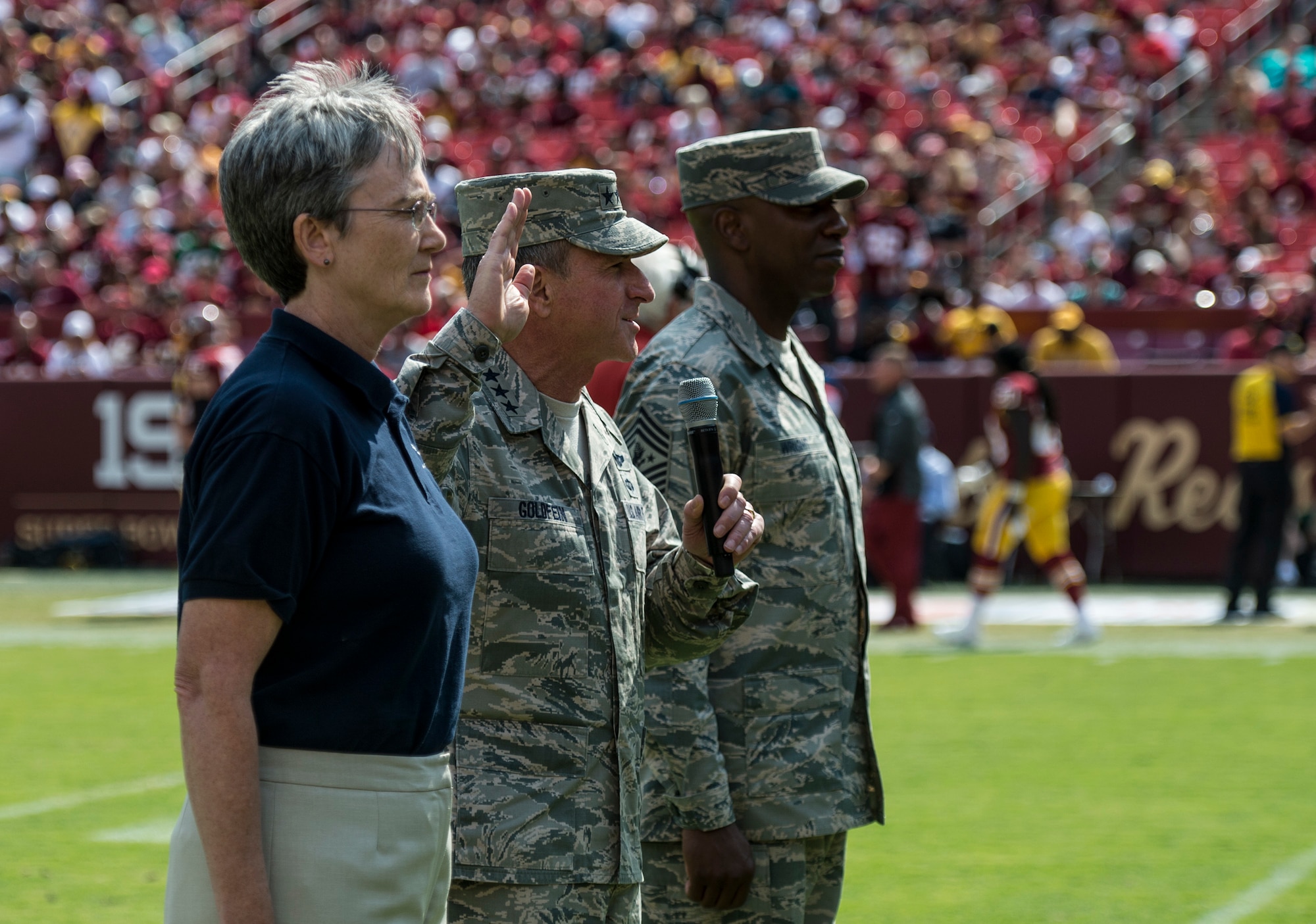 Secretary of the Air Force Heather Wilson, Chief of Staff of the Air Force Gen. David L. Goldfein and Chief Master Sgt. of the Air Force Kaleth O. Wright swear in delayed entry members during the Washington Redskins versus Philadelphia Eagles game at the FedExField in Hyattsville, Md., Sept. 10, 2017. The game was dedicated to the men and women of the U.S. Air Force in celebration of the service's 70th birthday. (U.S. Air Force photo by Senior Airman Rusty Frank/Released)