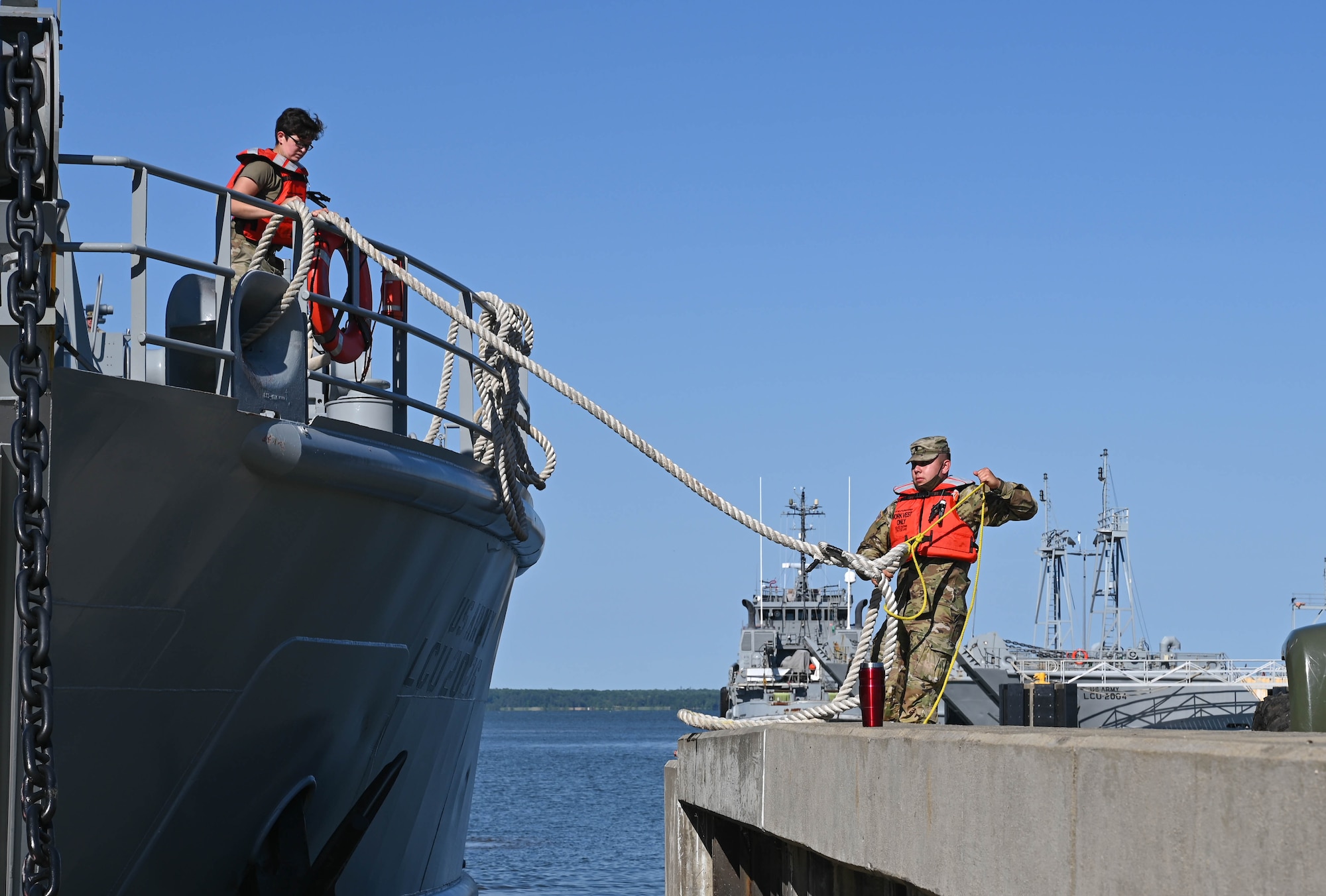 U.S. Soldiers prepare a Landing Craft Utility to transport equipment and gear during the Robert E. Rumens Marine Firefighting Symposium at Joint Base Langley-Eustis, Virginia, May 21, 2021. The LCU carried a fire truck and pump trailer to provide additional capabilities during the training. (U.S. Air Force photo by Senior Airman Sarah Dowe)