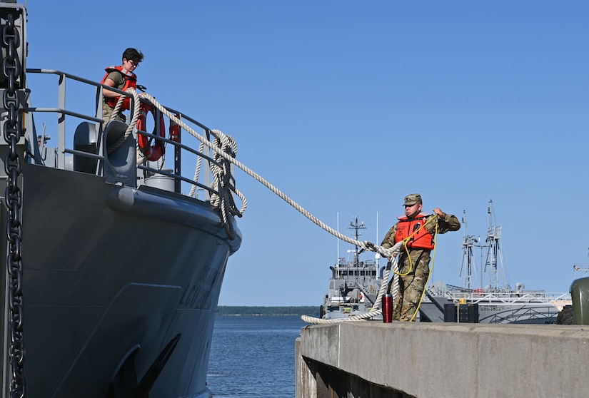 U.S. Soldiers prepare a Landing Craft Utility to transport equipment and gear during the Robert E. Rumens Marine Firefighting Symposium at Joint Base Langley-Eustis, Virginia, May 21, 2021. The LCU carried a fire truck and pump trailer to provide additional capabilities during the training. (U.S. Air Force photo by Senior Airman Sarah Dowe)