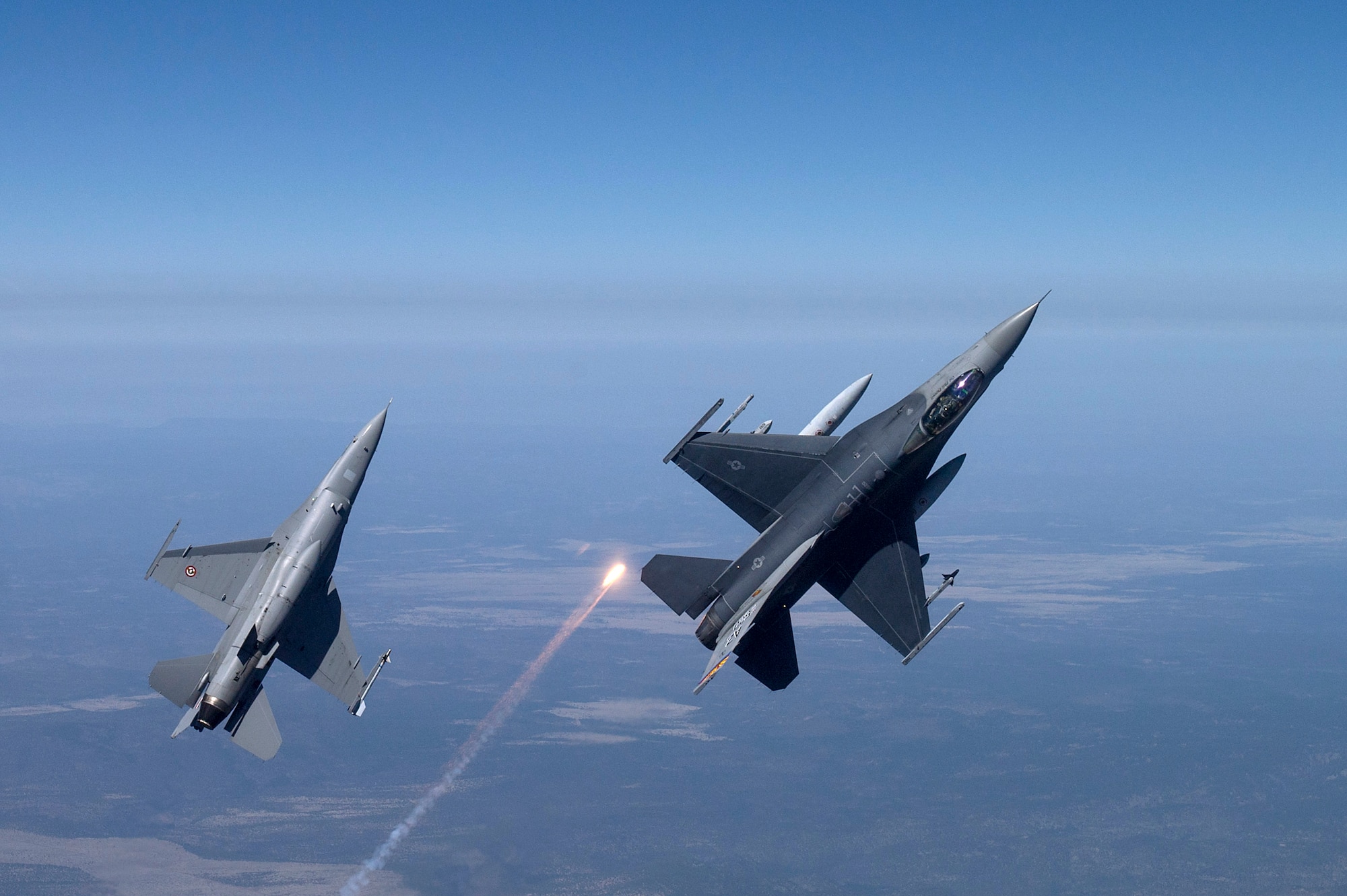 F-16 Fighting Falcons from the 162nd Wing, Tucson, Arizona fly over an training range on April 8, 2015. The 161st Wing manages a fleet of more than 70 F-16 C/D and Mid-Life Update Fighting Falcons. There are three flying squadrons and numerous maintenance units assigned to the wing. (U.S. Air Force photo/Master Sgt. Jeffrey Allen)