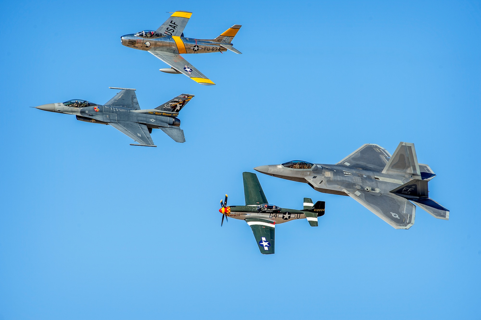 Four generations and over 70 years of U.S. Army Air Corps / U.S. Air Force air superiority, and the technological leaps that maintained it, are represented by a single formation of an F-22 "Raptor", F-86 "Sabre", F-16 "Fighting Falcon" and a P-51D "Mustang" during the Heritage Flight Training Course at Davis-Monthan AFB, Tucson, Ariz., Mar 5, 2016. (U.S. Air Force photo by J.M. Eddins Jr.)