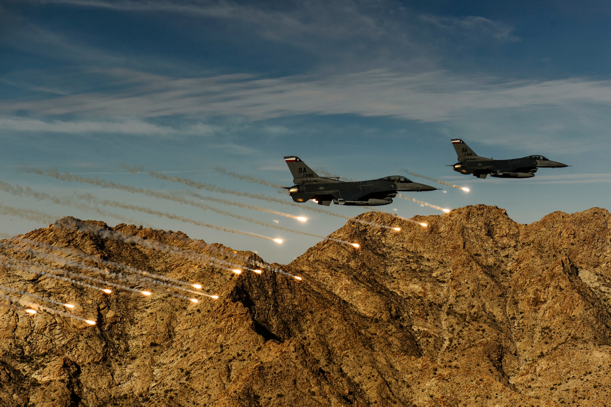 Two F-16C Fighting Falcons release flares while conducting low-level combat training during the Coronet Cactus exercise near Davis-Monthan Air Force Base, Ariz. The F-16s are assigned to the , assigned to the 182nd Fighter Squadron. This exercise provides realistic combat training for student fighter pilots from air-to-air combat to dropping inert and live ordnance. (U.S. Air Force photo/Staff Sgt. Jonathan Snyder/3rd Combat Camera Squadron)