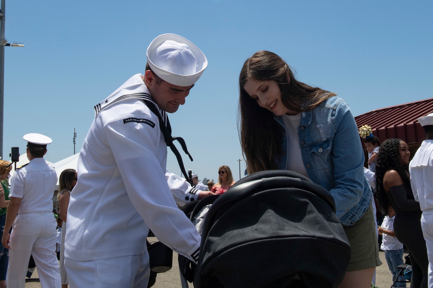Aviation Ordnanceman Airman Brian Escobaradams, from Bremerton, Wash., greets his wife and new born baby.