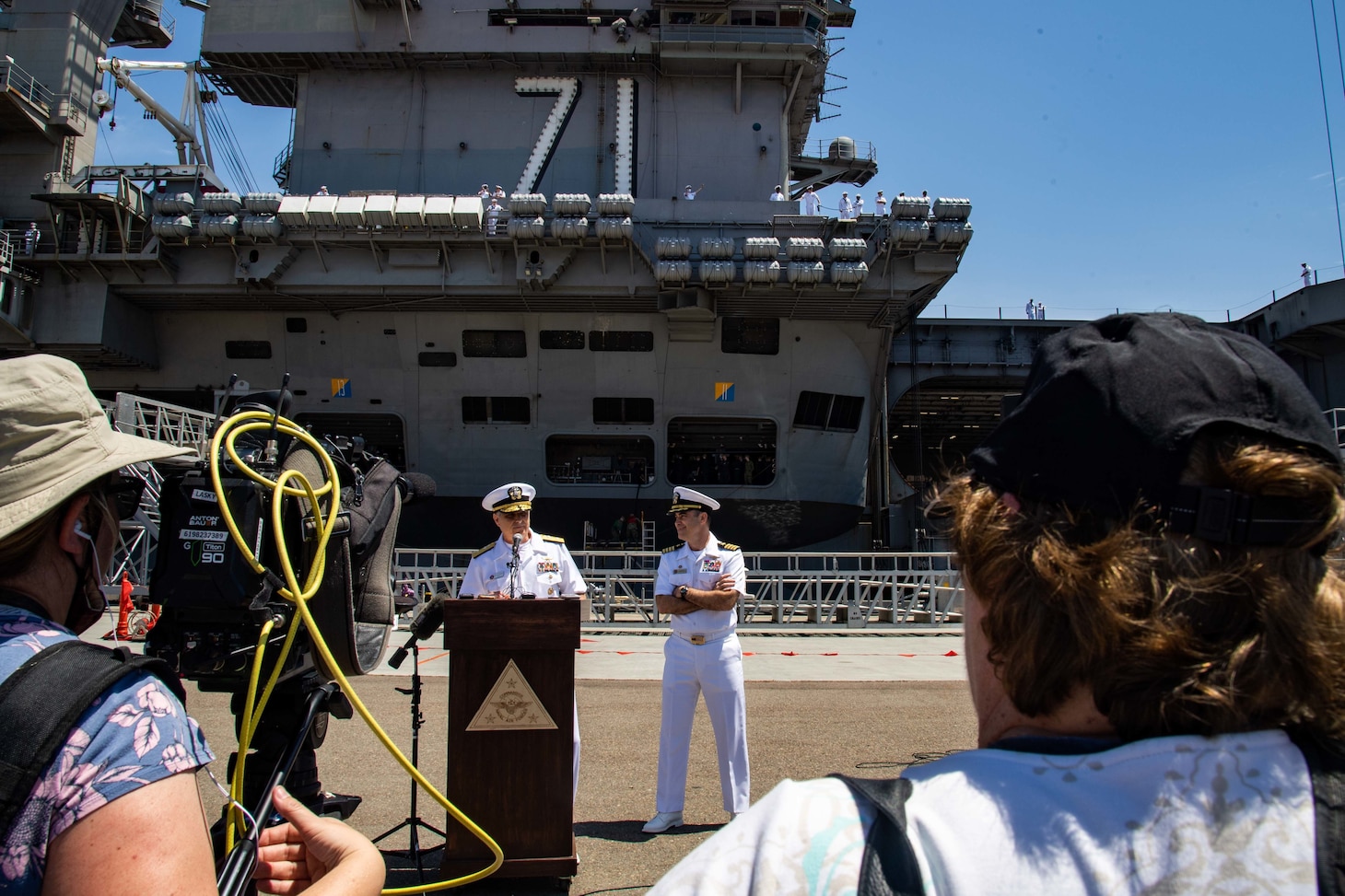 Rear Adm. Doug Verissimo, Commander, Carrier Strike Group 9, left, and Capt. Eric Anduze, commanding officer of the aircraft carrier USS Theodore Roosevelt (CVN 71), deliver remarks during a press briefing.