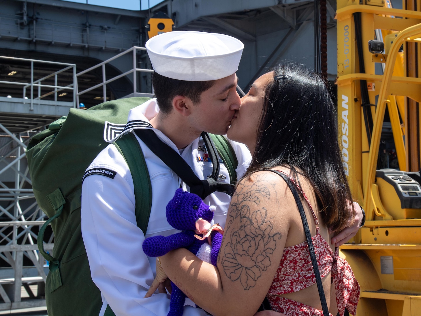 Aerographer’s Mate 2nd Class Daniel Campos, from Manassas, Va., greets his family on the pier.