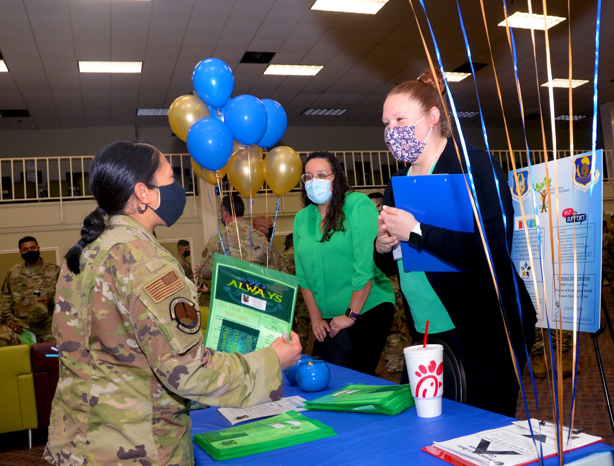 Maj. Joya Gamara, 854th Combat Operations Squadron chief of combat plans division, speaks with Christina Avalos, 960th Cyberspace Wing psychological health volunteer, and Christyn Mundy, 960th CW psychological health intern, during the Mental Health and Resiliency Fair, May 1, 2021, at Joint Base San Antonio-Lackland, Texas. (U.S. Air Force photo by Tech. Sgt. Samantha Mathison)