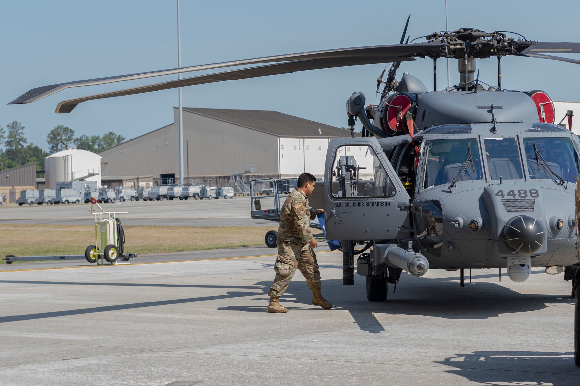 Photo of an Airman revealing a new commander's name on an aircraft