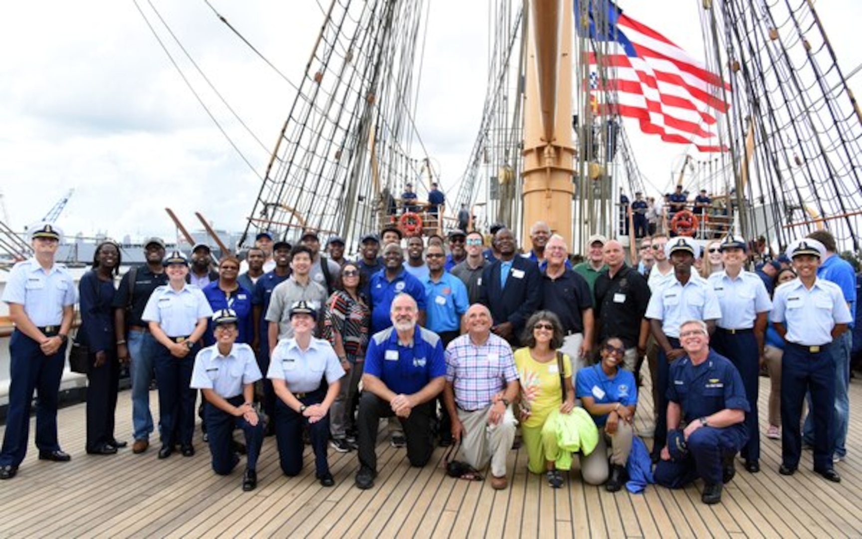 The Coast Guard Cutter Barque Eagle's crew gather with local community and industry members for a group photo on the deck of the Eagle Aug. 3, 2018 in Norfolk, Virginia. The local community and industry members consisted of people from Minority Serving Institutions, Norfolk State University, Elizabeth City State University, Hampton University and Virginia State University. U.S. Coast Guard Photo by Cmdr. Ann Bassolino.