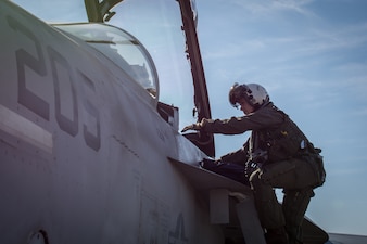 Cmdr. Leslie Mintz, executive officer of the “Blacklions” of Strike Fighter Squadron (VFA) 213, climbs into an F/A-18F Super Hornet on board Naval Air Station Oceana