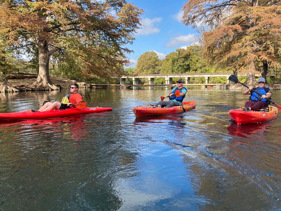 Service members kayaking on San Marcos River.