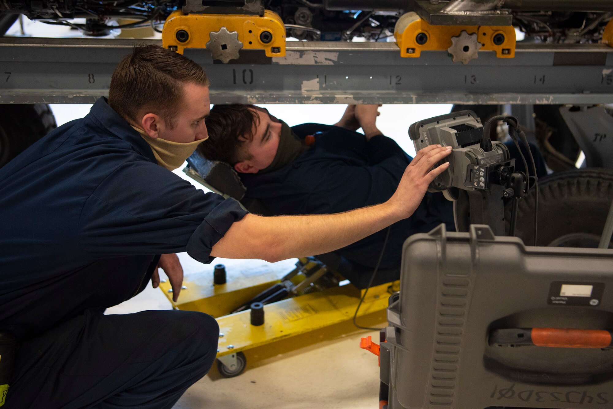 Senior Airman Steven Martin, left, and Staff Sgt. James Leonard, 49th Component Maintenance Squadron jet engine intermediate maintenance craftsmen, use a borescope to inspect narrow and hard-to-reach areas inside a F-16 Viper engine, May 13, 2021, on Holloman Air Force Base, New Mexico. The 49th CMS provides on and off-equipment maintenance support for assigned F-16 aircraft enabling Combat Air Force pilot training. (U.S. Air Force photo by Airman 1st Class Jessica Sanchez)