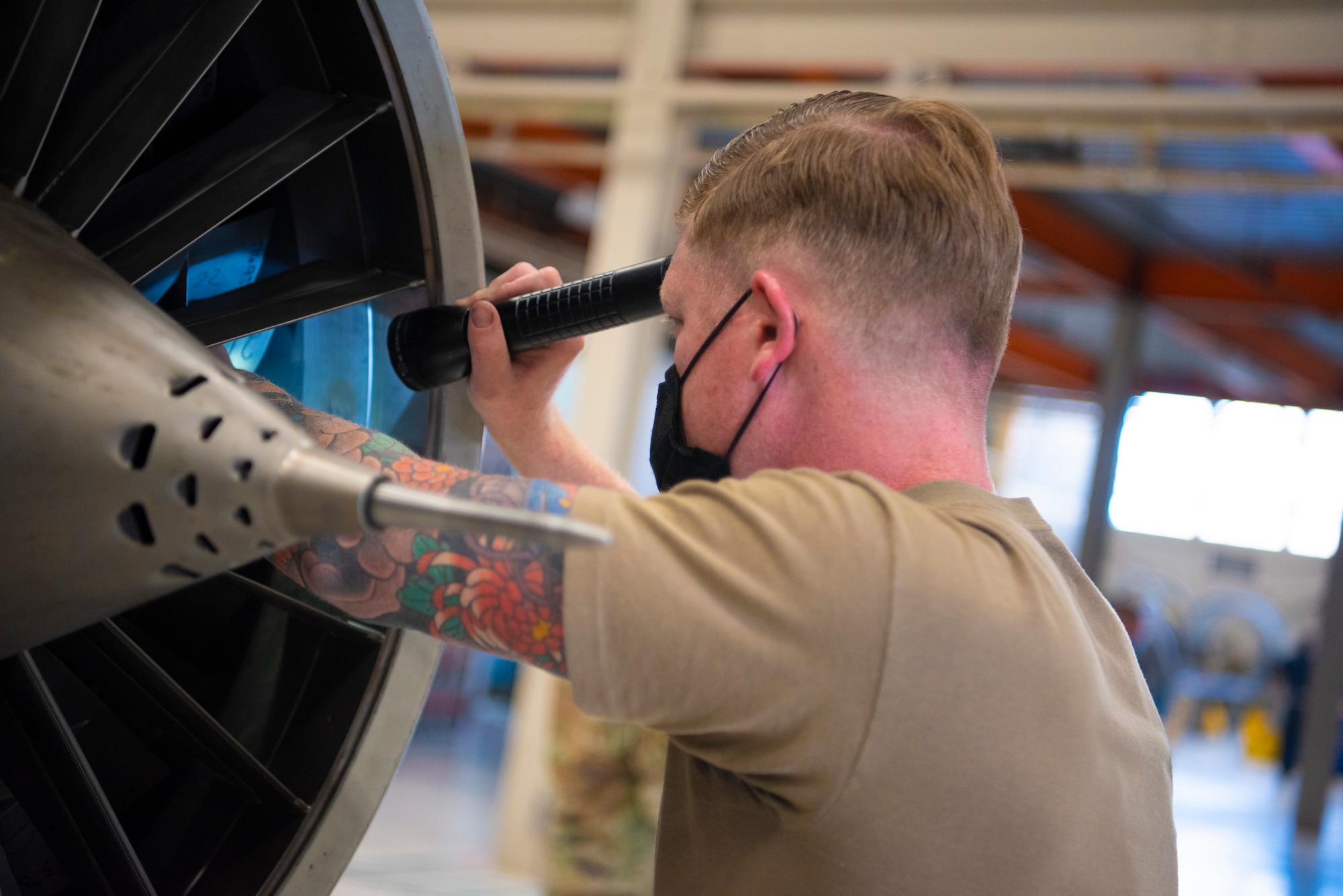 Staff Sgt. Dustin Bayer, 49th Component Maintenance Squadron dock chief, inspects the inside of a F-16 Viper engine fan for foreign object debris, May 13, 2021, on Holloman Air Force Base, New Mexico. Internal FOD is any article or substance not from the aircraft or system, which could potentially cause damage. (U.S. Air Force photo by Airman 1st Class Jessica Sanchez)