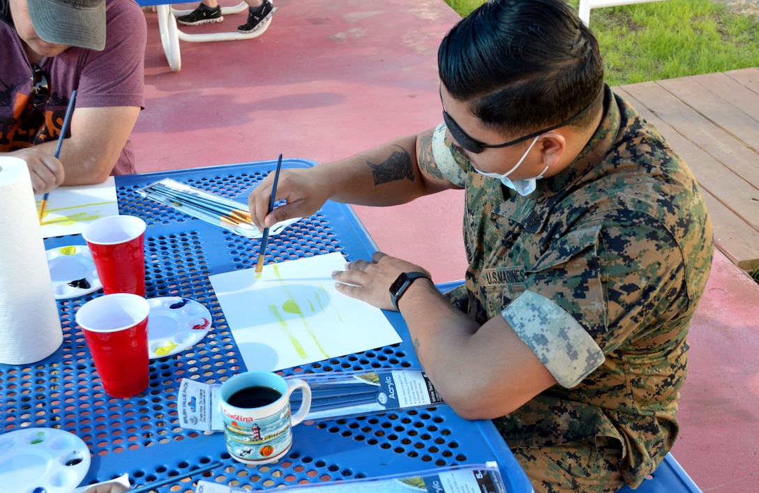 U.S. Marine paints with water colors.