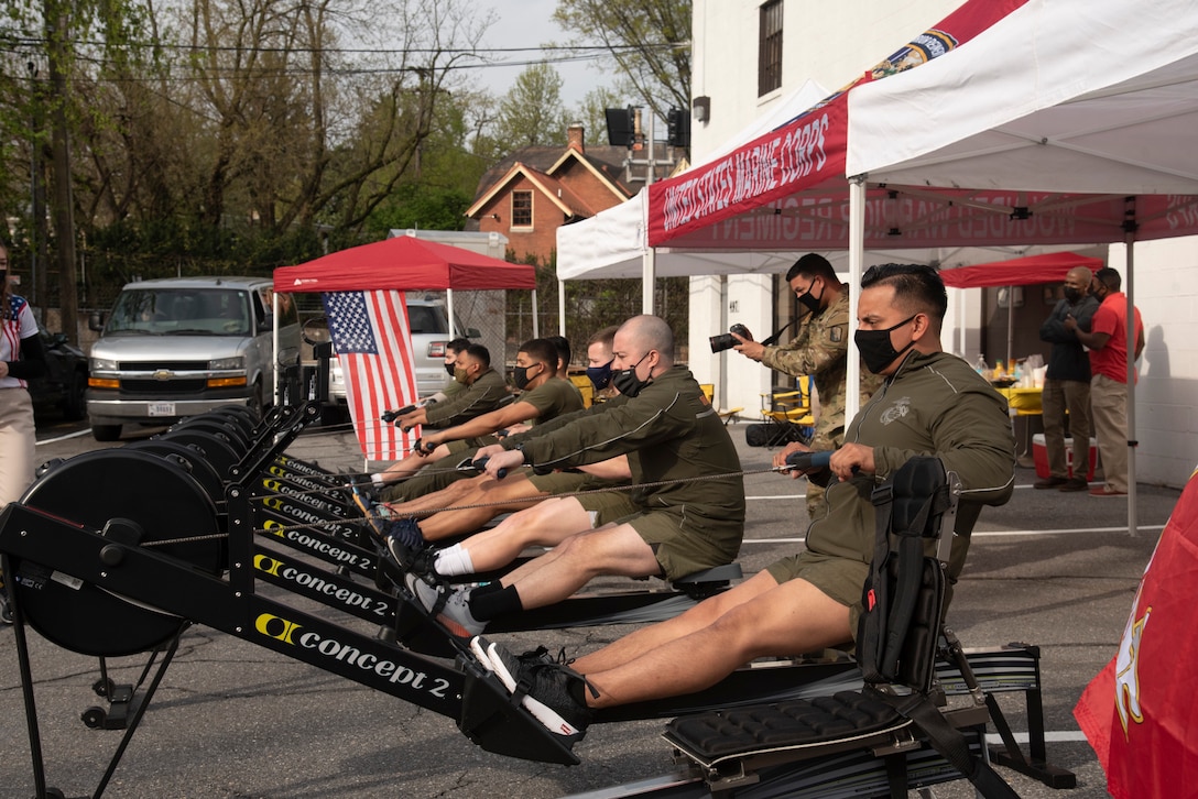 U.S. Marines warm up on rowing machines.