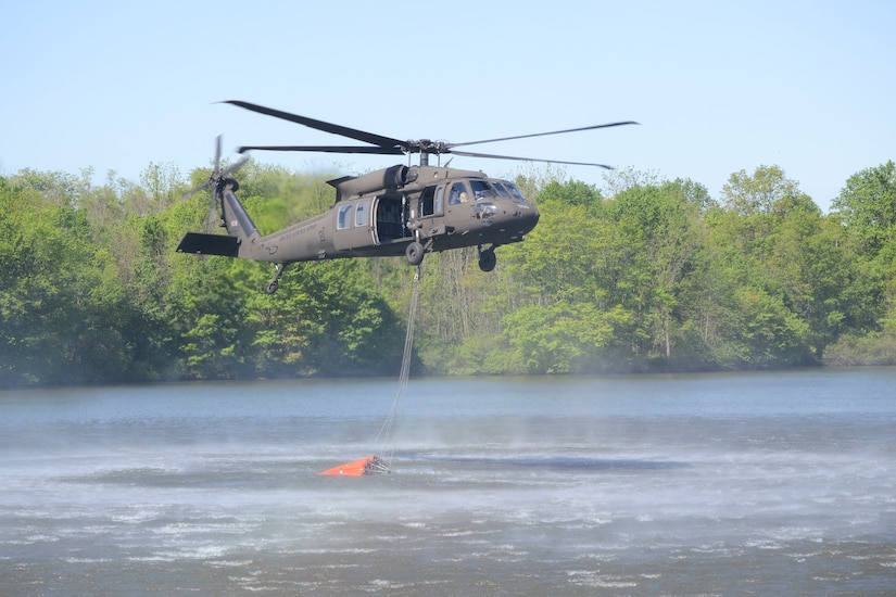 One CH-47 Chinook and two UH-60 Black Hawk helicopters conduct water bucket training May 11 at Memorial Lake State Park and Fort Indiantown Gap in coordination with safety and conservation ground personnel.