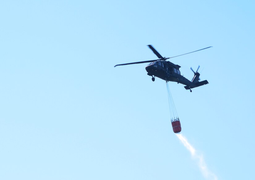 One CH-47 Chinook and two UH-60 Black Hawk helicopters conduct water bucket training May 11 at Memorial Lake State Park and Fort Indiantown Gap in coordination with safety and conservation ground personnel.