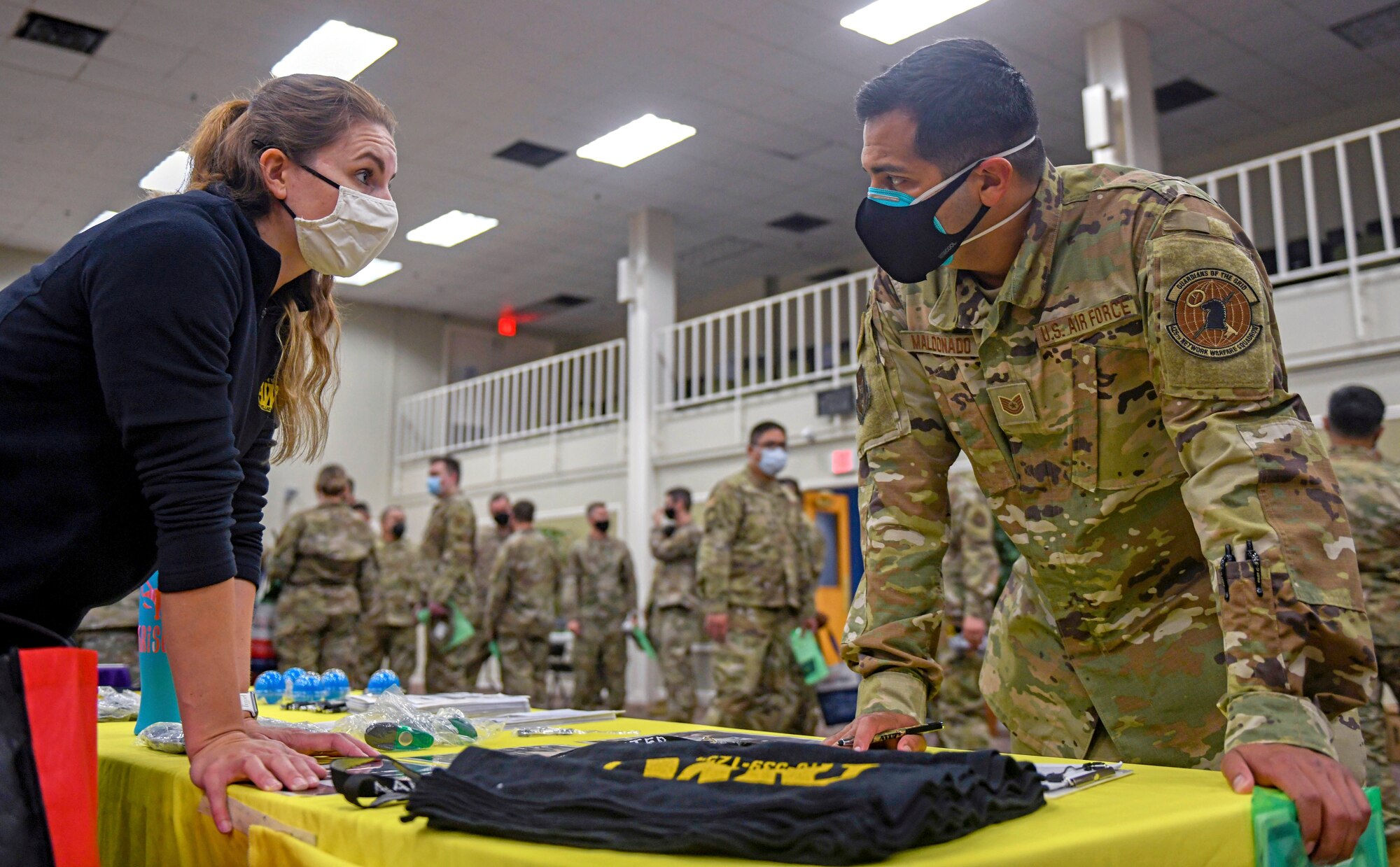 Kristen Myers, Ft. Sam Houston Army Wellness Center health education advocate, talks about physical health and fitness with Tech. Sgt. Damon Maldonado, 426th Network Warfare Squadron cyber warfare operator, during the 960th Cyberspace Wing Mental Health and Resiliency Fair, May 1, 2021, at Joint Base San Antonio-Lackland, Texas. (U.S. Air Force photo by Airman First Class Tyler McQuiston)