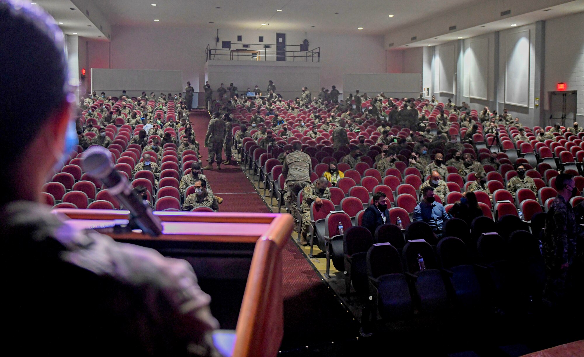 Capt. Jamillah Gonzalez, 960th Cyberspace Wing executive officer, performs sound checks while Airmen and families find their seats in the Bob Hope Performing Arts Center prior to the showing of “Ernie and Joe: Crisis Cops,” May 1, 2021, at Joint Base San Antonio-Lackland, Texas. (U.S. Air Force photo by Airman First Class Tyler McQuiston)