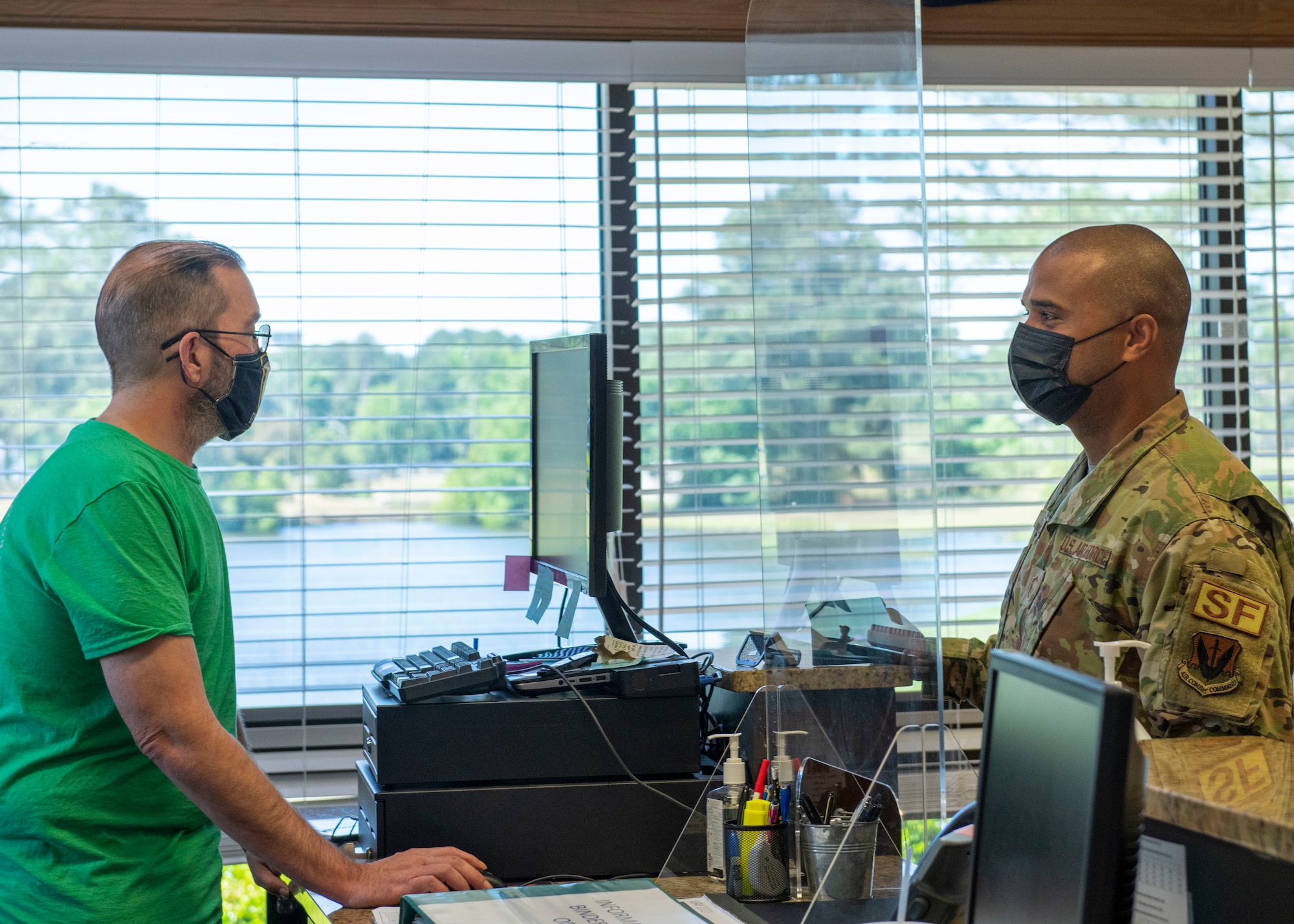 Senior Master Sgt. Jordan Locklear, right, 4th Security Forces Squadron security forces manager, checks out rental equipment with Michael Davis, Outdoor Recreation cashier on Seymour Johnson Air Force Base, North Carolina, May 13, 2021.