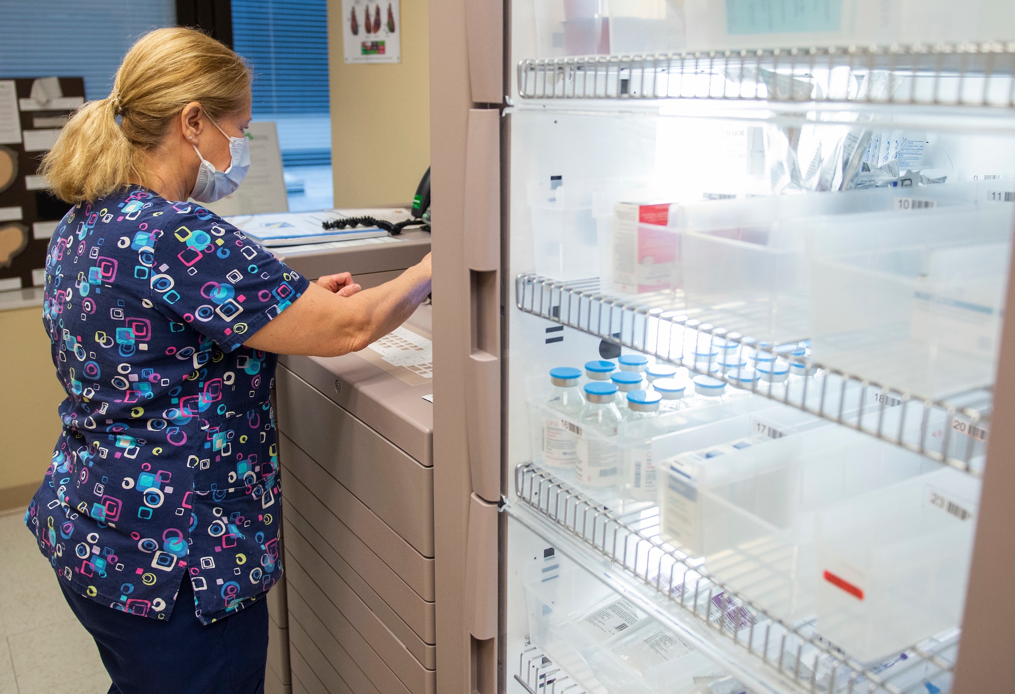 Brenda Fox, a registered nurse with the 88th Medical Group, retrieves medication to be dispensed to a patient inside the Wright-Patterson Air Force Base, Ohio Medical Center, April, 28, 2021. The medical center is open 24 hours a day with medical personnel standing by to treat anyone that comes through their door. (U.S. Air Force photo by Wesley Farnsworth)