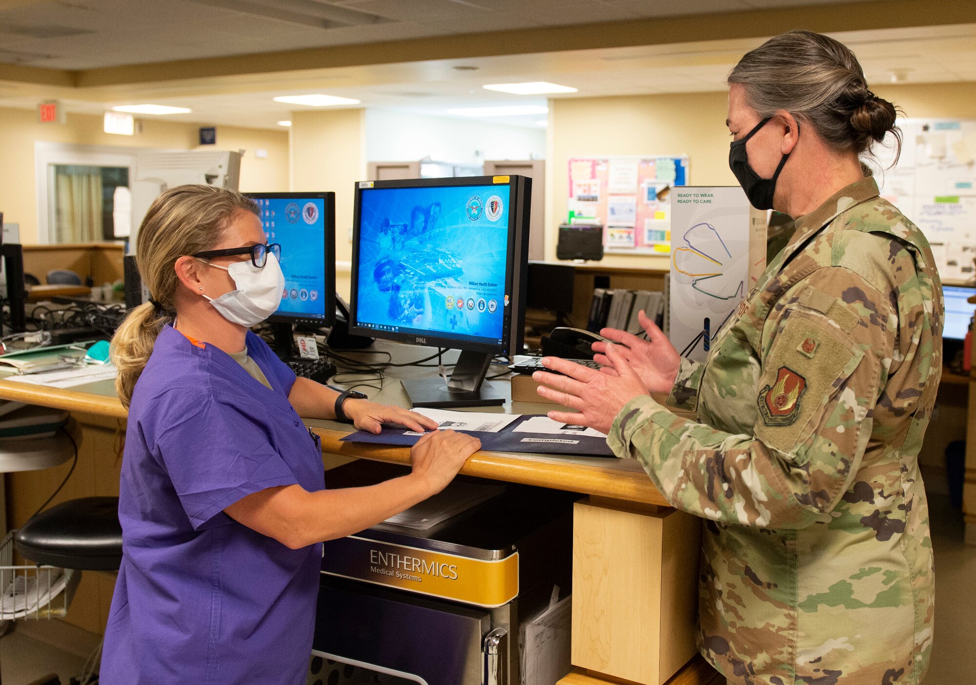 U.S. Air Force Col. Rachelle Hartze, 88th Medical Group master clinician and evening shift in-house supervisor, talks with Capt. Angela Leonardo, a registered nurse with the 88th Medical Group, inside the emergency room of the Wright-Patterson Air Force Base, Ohio Medical Center, April, 28, 2021. The medical center is open 24 hours a day with medical personnel standing by to treat anyone that comes through their door. (U.S. Air Force photo by Wesley Farnsworth)