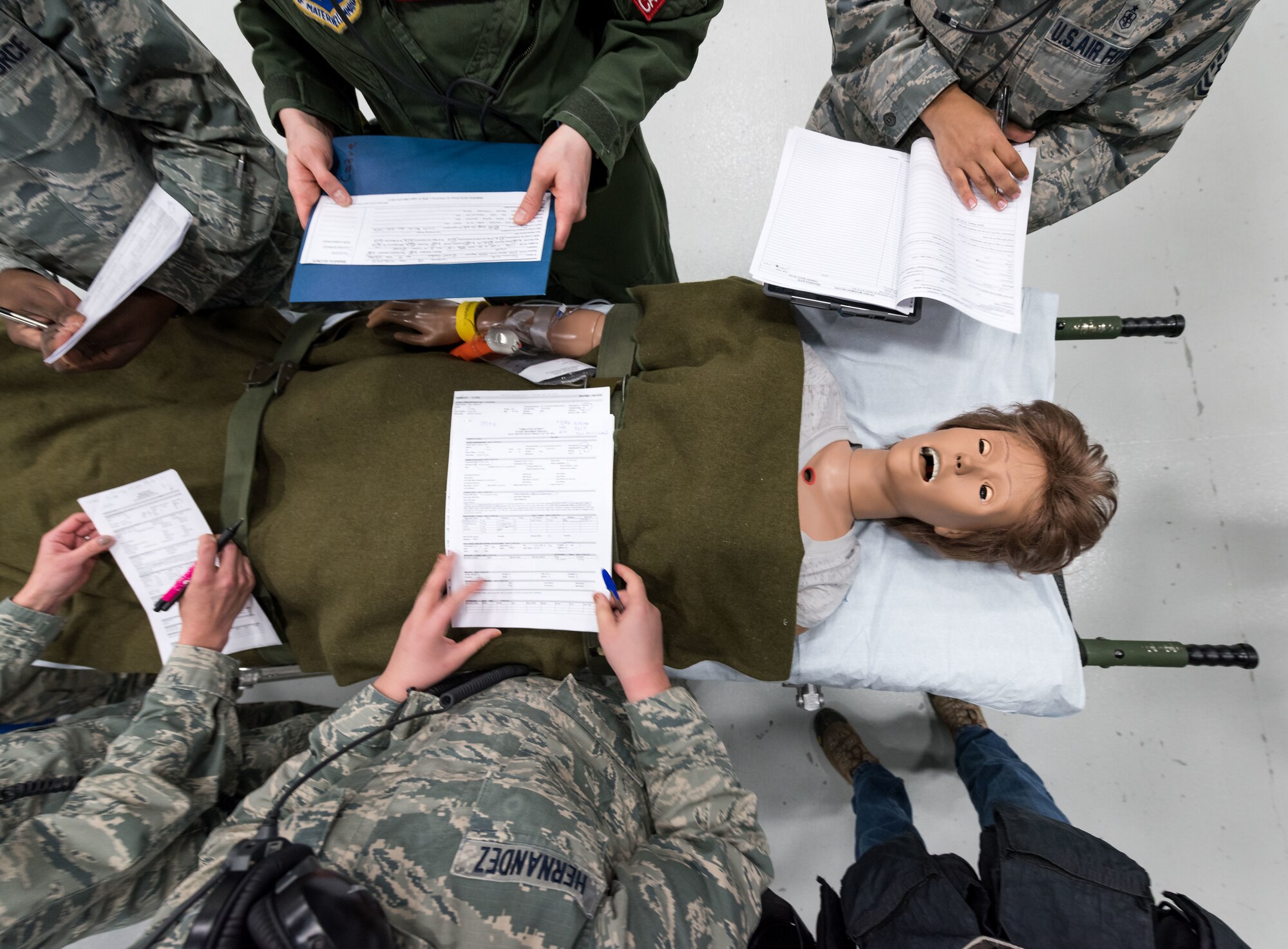 Students read patient briefs from actual Aeromedical Evacuation missions before boarding a C-130 mockup to treat simulated patients during the Flight Nurse and Aeromedical Technician Course at the 711th Human Performance Wing's U.S. Air Force School of Aerospace Medicine at Wright Patterson AFB, Ohio, Jan. 29, 2018. (U.S. Air Force photo by J.M. Eddins Jr.)