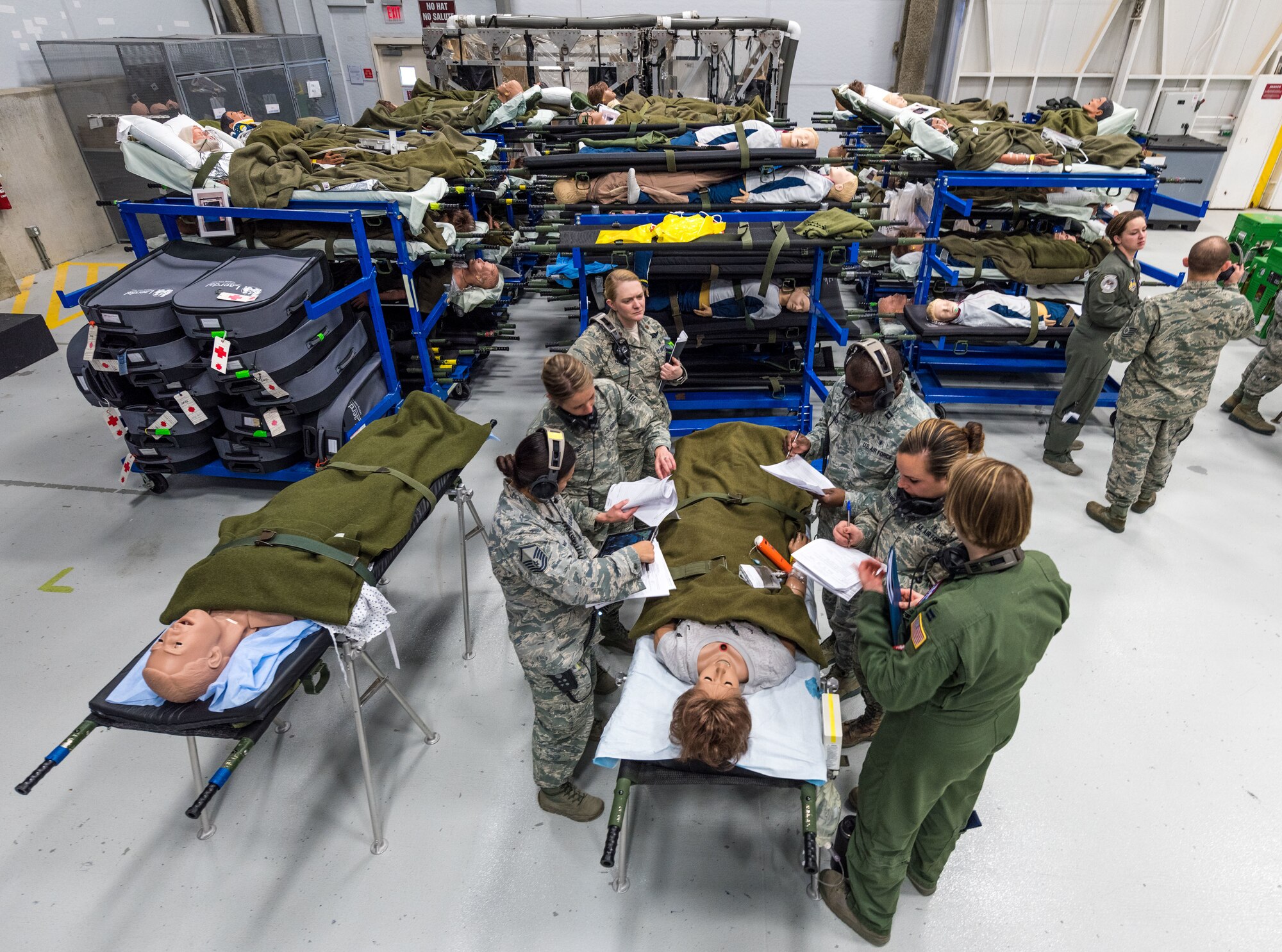Flight Nurse and Aeromedical Technician Course students discuss patient briefs from actual Aeromedical Evacuation missions before boarding a C-130 mockup to treat simulated patients at the 711th Human Performance Wing's U.S. Air Force School of Aerospace Medicine at Wright Patterson AFB, Ohio, Jan. 29, 2018. (U.S. Air Force photo by J.M. Eddins Jr.)
