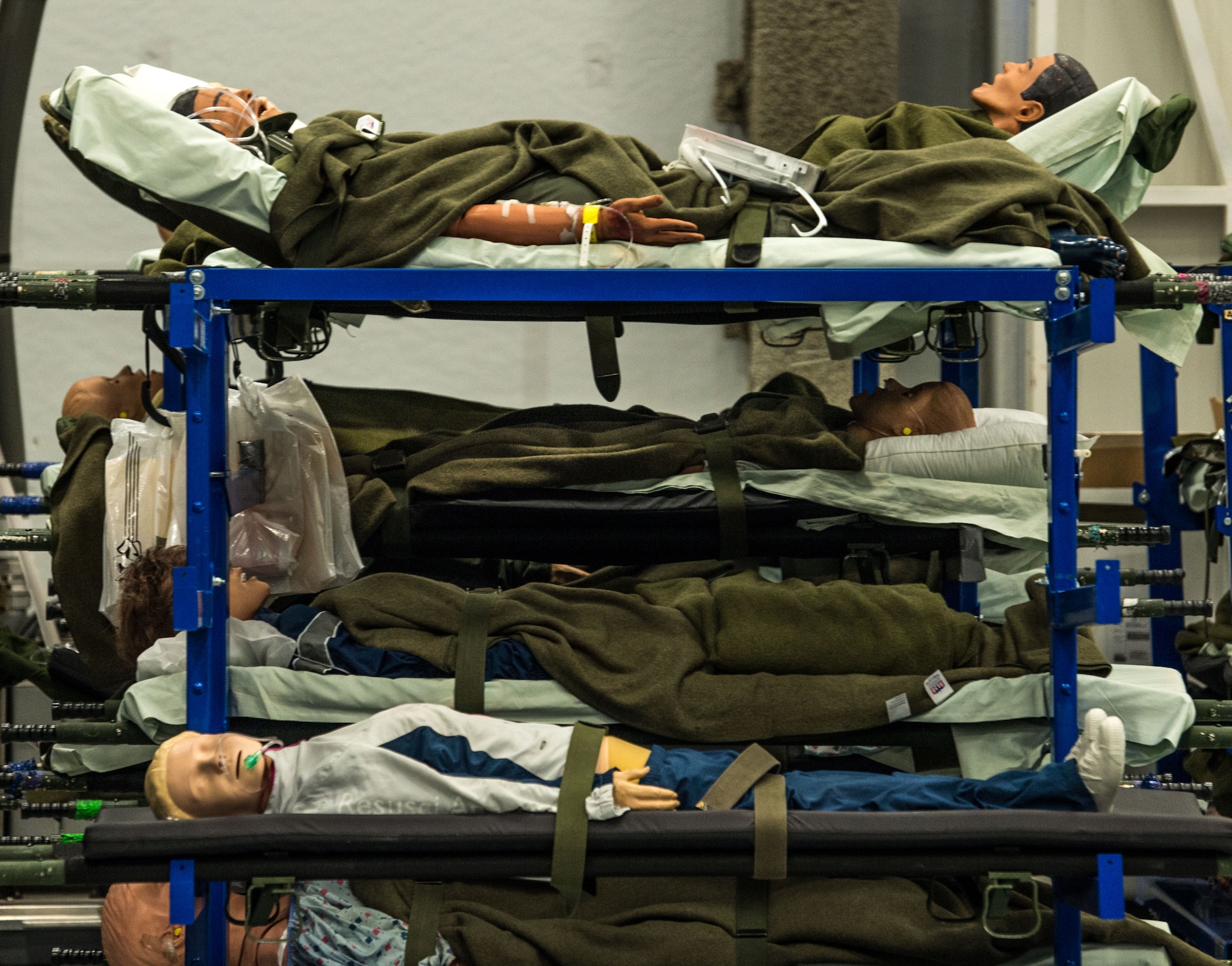 Patient simulators used in the aeromedical evacuation training of active-duty, reserve and ANG Airmen, as well as, members of other services and partner nations, aboard a C-130 mockup during the Flight Nurse and Aeromedical Technician Course, await use on racks in the high bay area or the 711th Human Performance Wing's U.S. Air Force School of Aerospace Medicine at Wright Patterson AFB, Ohio, Jan. 29, 2018. (U.S. Air Force photo by J.M. Eddins Jr.)