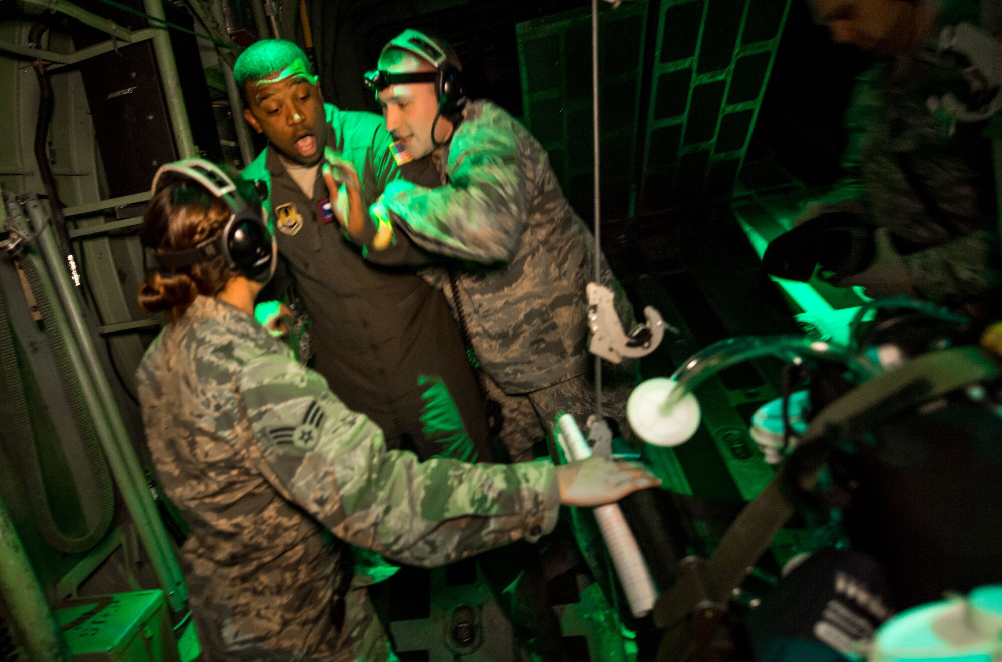 Flight Nurse and Aeromedical Technician Course students, Senior Airman Priscilla Oster and Airman 1st Class Travis Hammack, try to calm a role playing "psych patient", Tech Sgt. Donald Ennis, during a simulated Aeromedical Evacuation mission aboard a C-130 mockup at the 711th Human Performance Wing's U.S. Air Force School of Aerospace Medicine at Wright Patterson AFB, Ohio, Jan. 29, 2018. (U.S. Air Force photo by J.M. Eddins Jr.)
