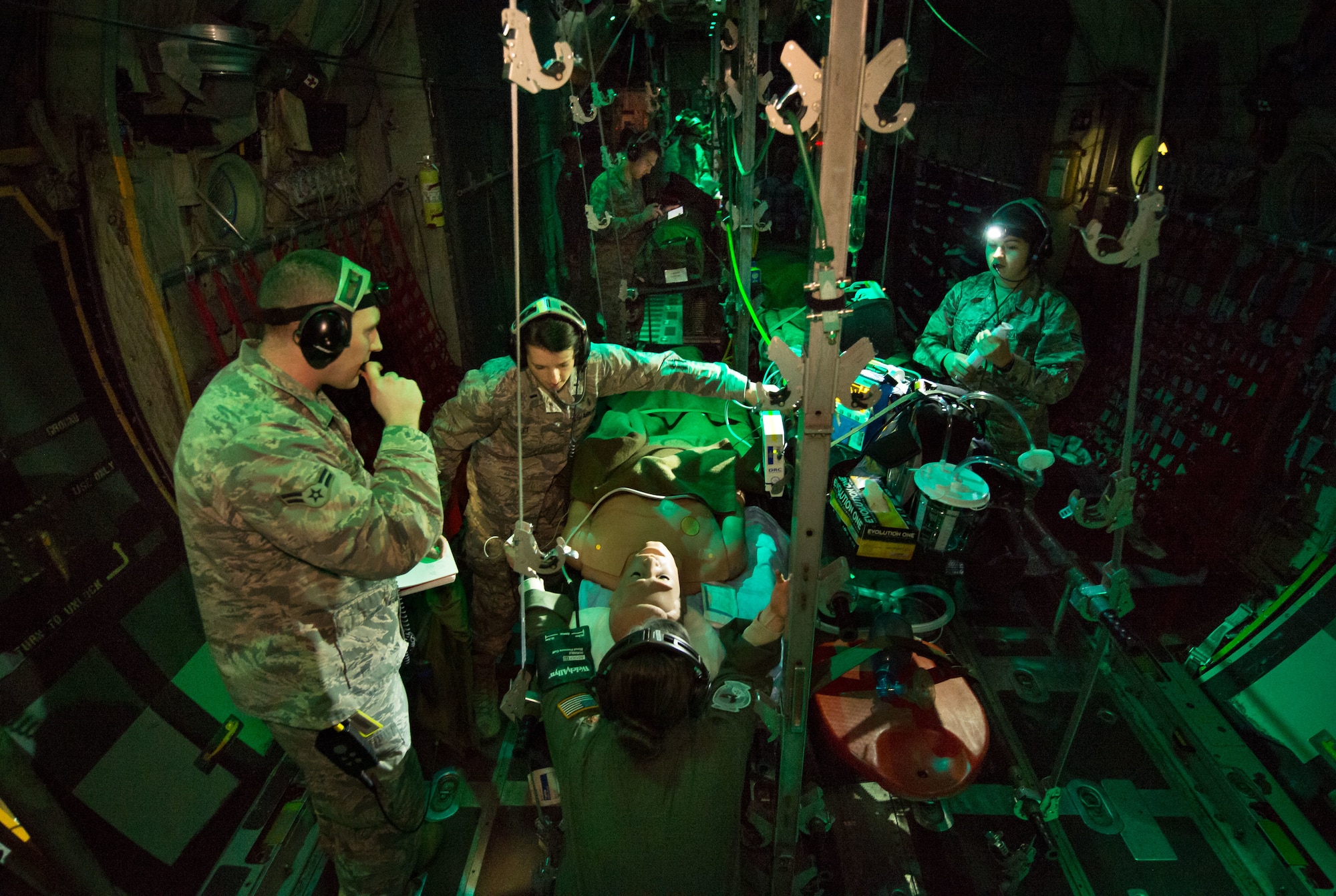 Flight Nurse and Aeromedical Technician Course students care for a simulated patient during a simulated Aeromedical Evacuation mission aboard a C-130 mockup at the 711th Human Performance Wing's U.S. Air Force School of Aerospace Medicine at Wright Patterson AFB, Ohio, Jan. 29, 2018. (U.S. Air Force photo by J.M. Eddins Jr.)