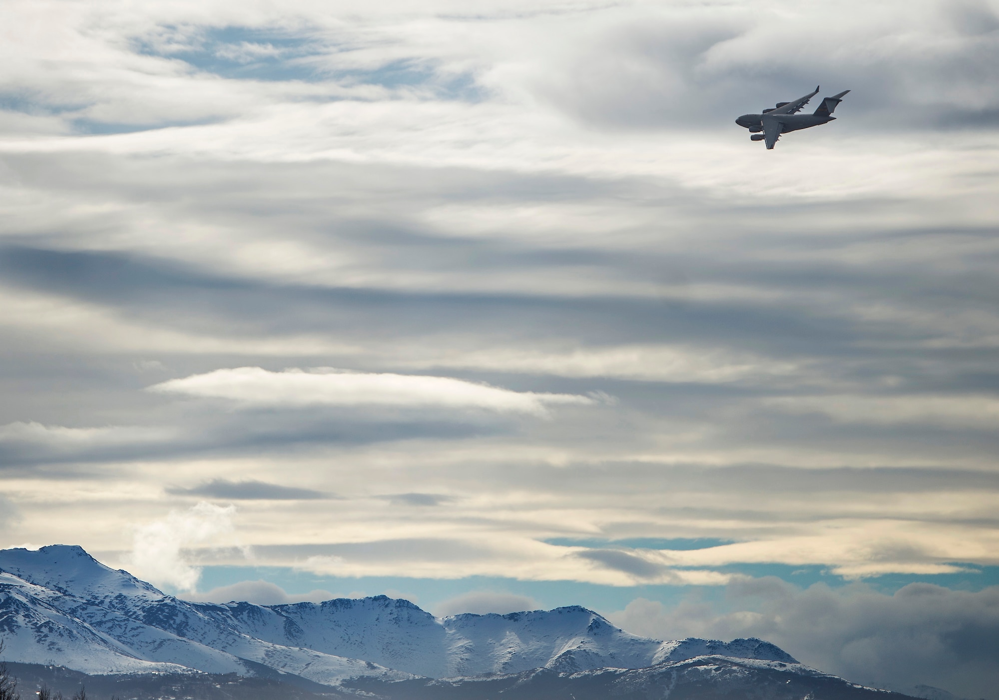 A C-17 Globemaster III flies over Joint Base Elmendorf-Richardson, Alaska, during a training sortie March 24, 2016. Training sorties are imperative to pilot development and overall mission effectiveness. (U.S. Air Force photo/Senior Airman James Richardson)